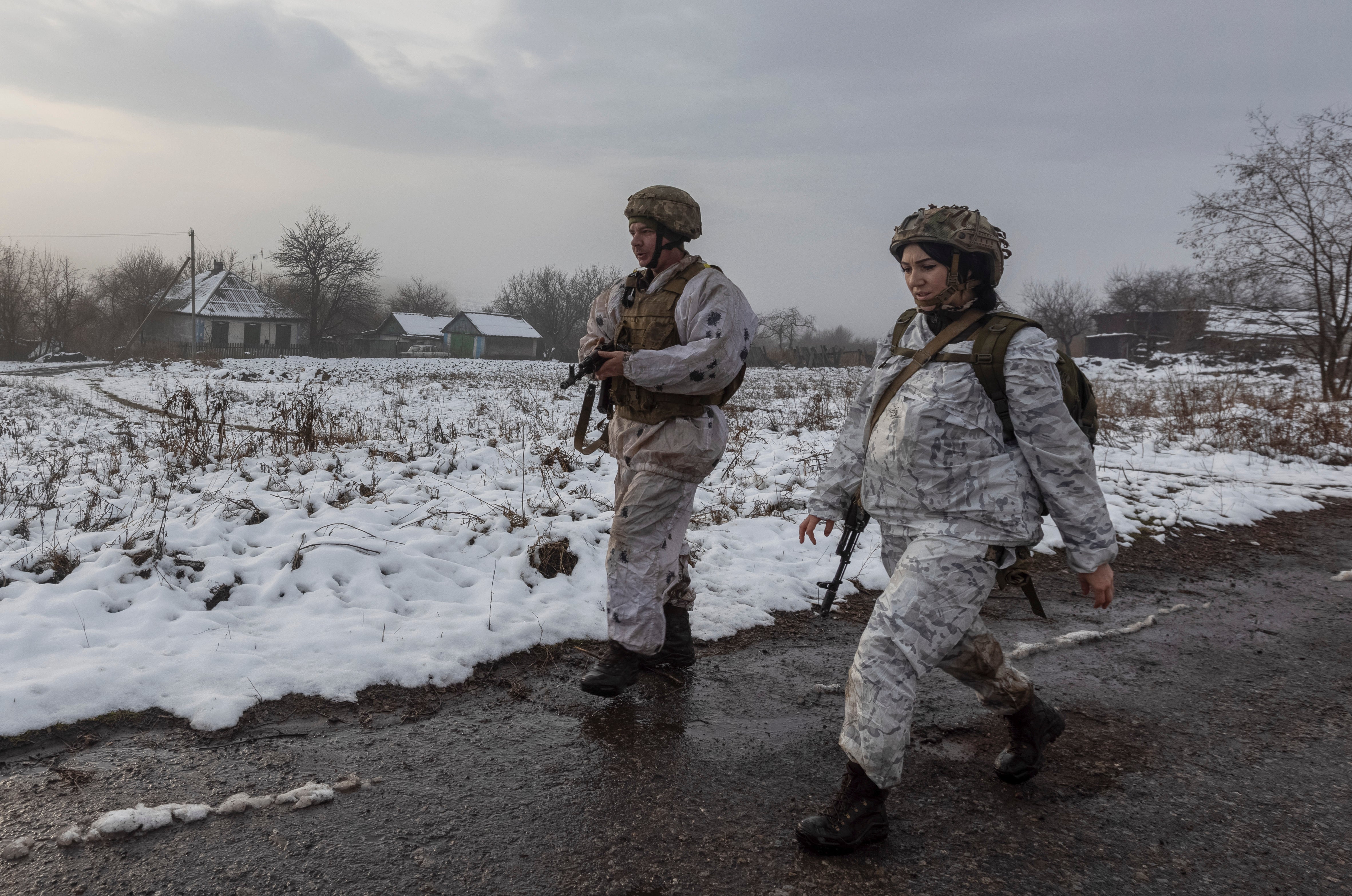 Ukrainian soldiers walk at the line of separation from pro-Russian rebels near Katerinivka, Donetsk region