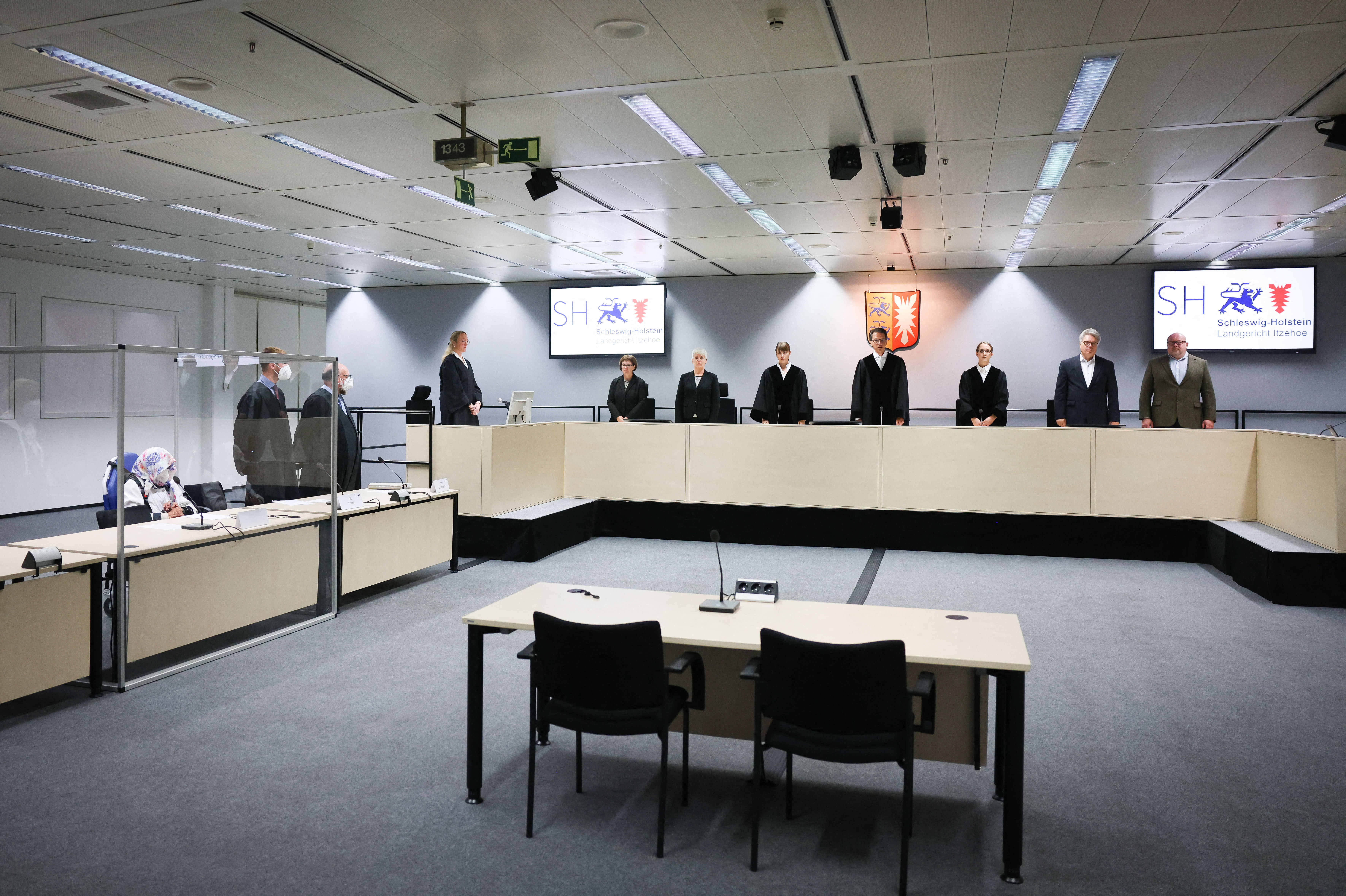 File: 96-year-old defendant Irmgard F. (L), a former secretary for the SS commander of the Stutthof concentration camp, sits in the courtroom next to her lawyers Niklas Weber (2ndL) and Wolf Molkentin (3rdL), as the presiding judge Dominik Gross (4thR) and his team stand at the start of her trial at the courtroom in Itzehoe, northern Germany, on 19 October 2021