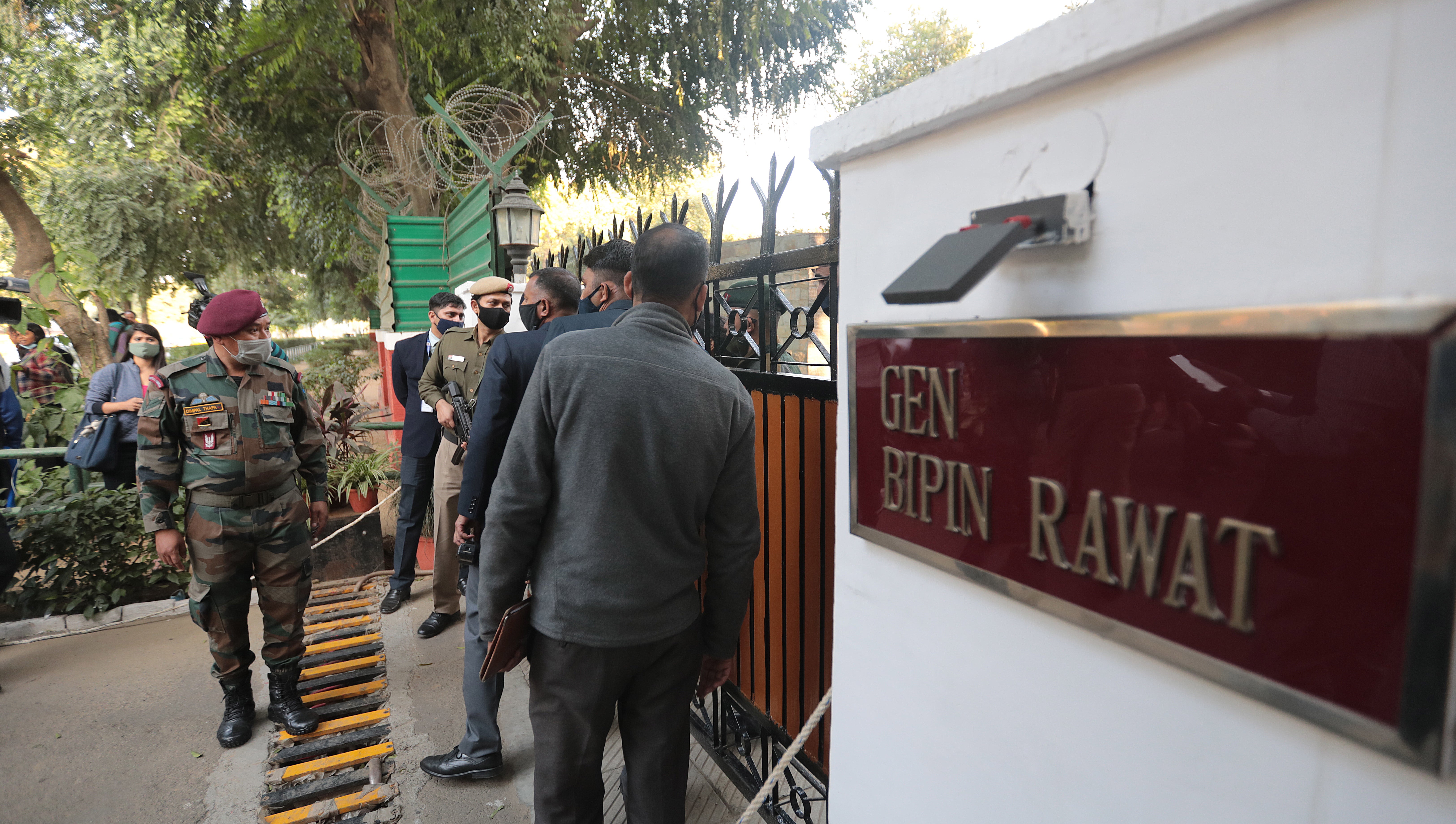 People gather outside General Bipin Rawat’s residence in New Delhi