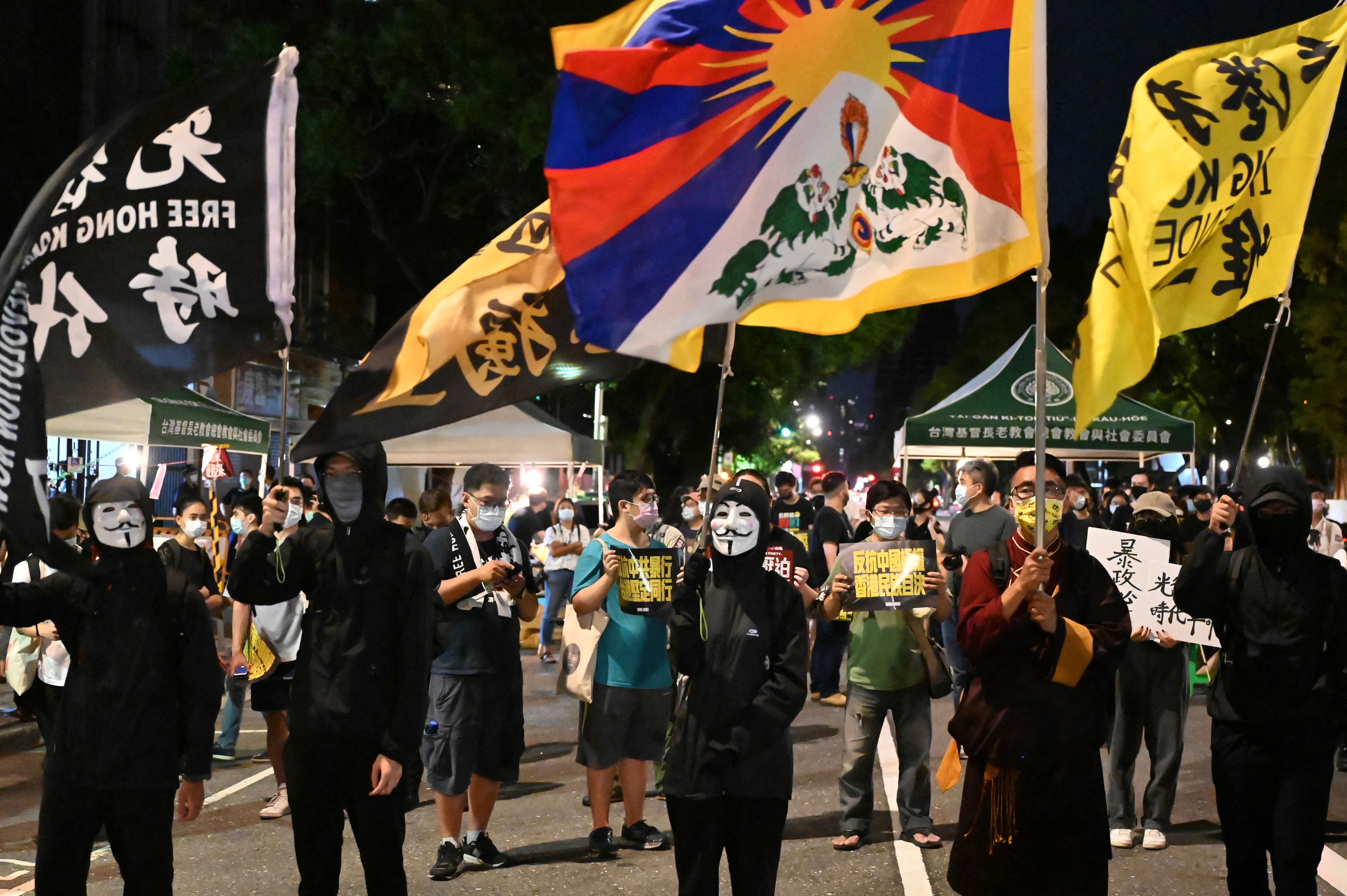 China wants to quell opposition, such as these pro-Tibet and ‘Free Hong Kong’ demonstrators outside the parliament in Taipei