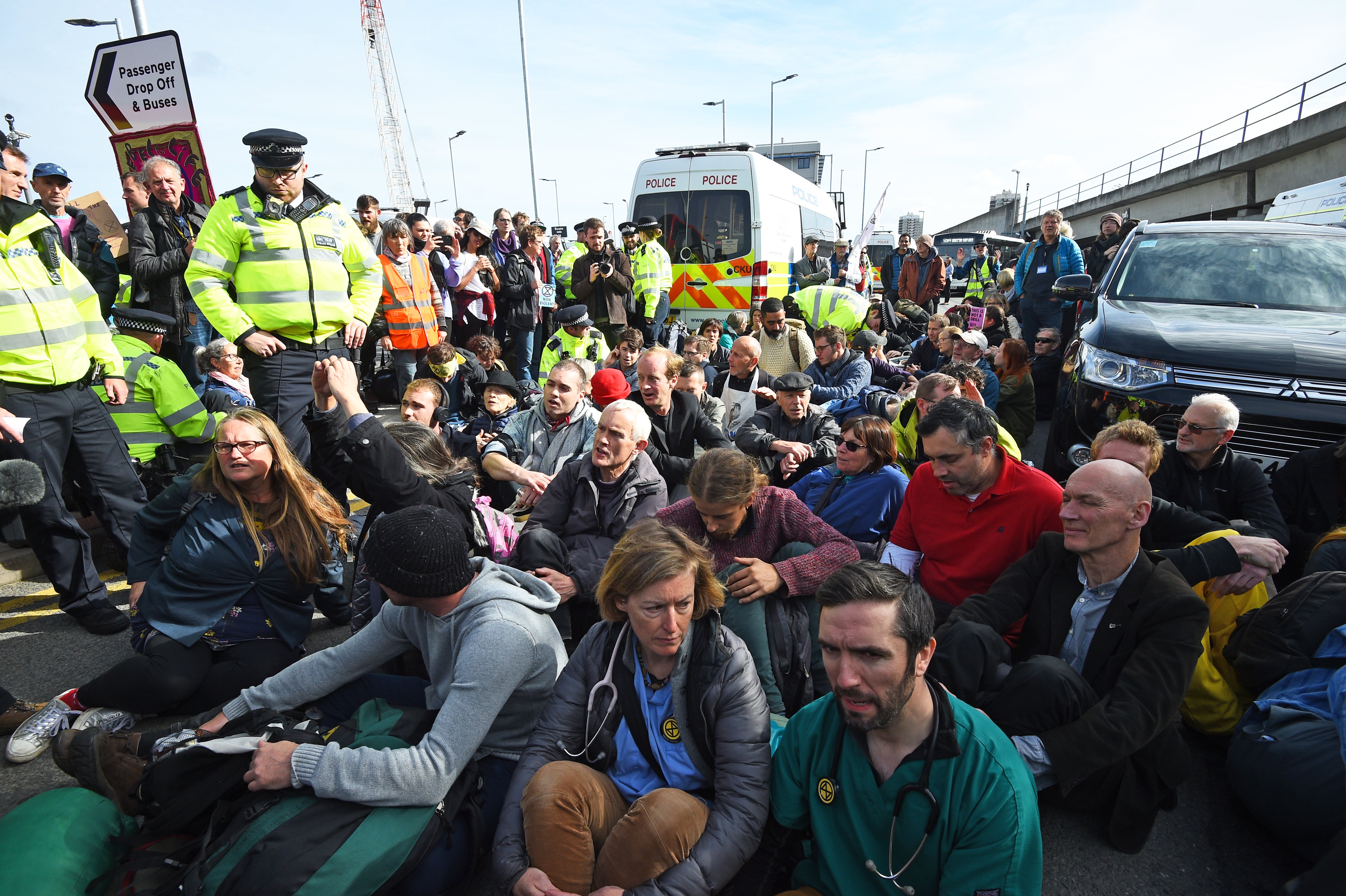 Protesters block the road outside City Airport during an Extinction Rebellion climate change protest