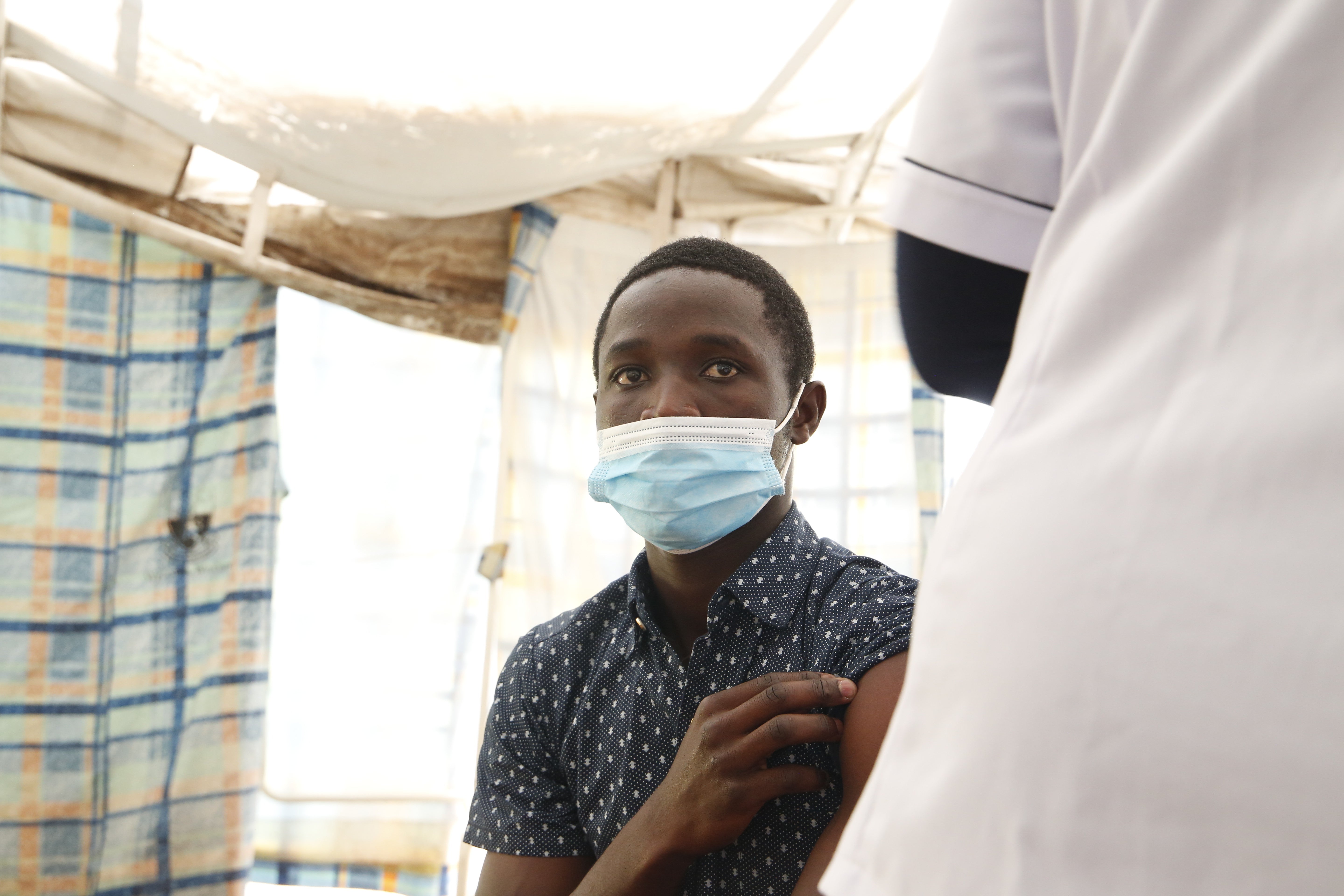 Austin Odiwuor waits to get vaccinated at Kenyatta National Hospital