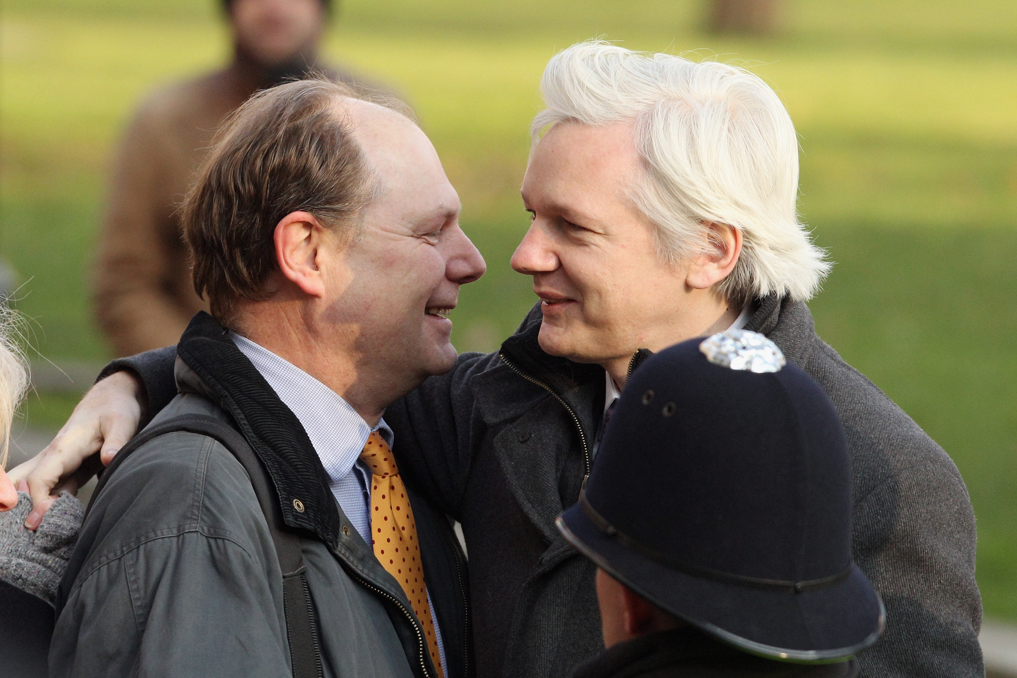 Assange embraces Smith, the founder of the Frontline Club who put up the majority of his bail money