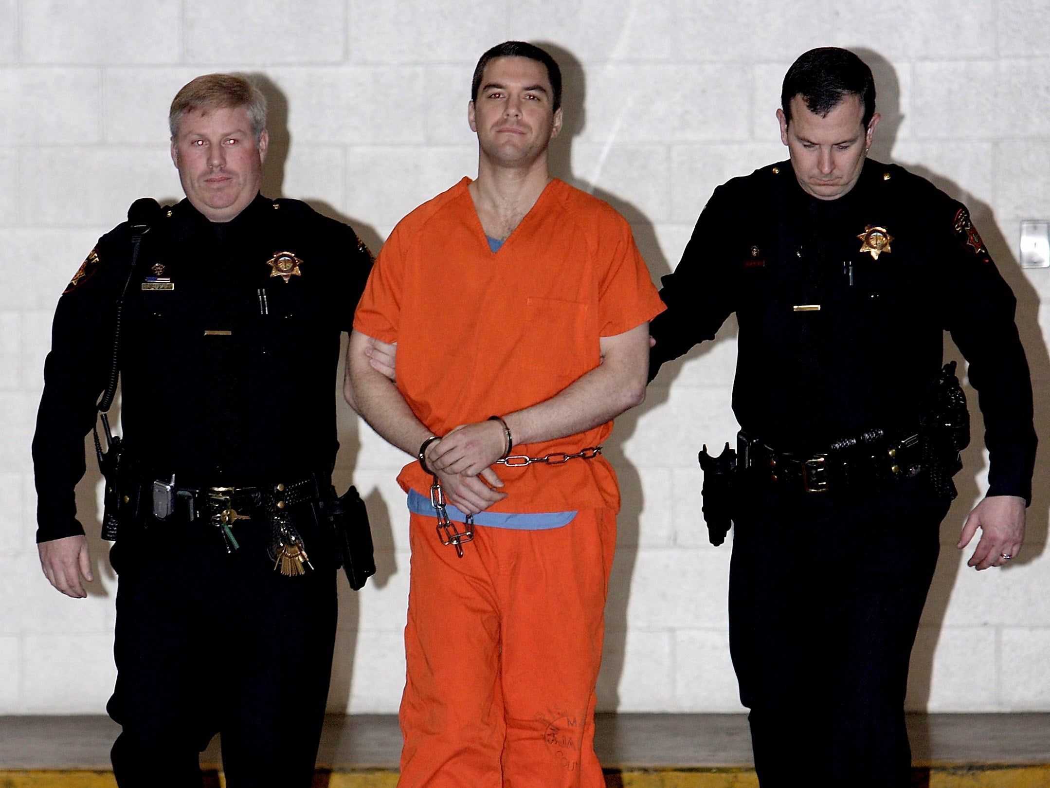 Convicted murderer Scott Peterson is escorted by San Mateo County Sheriff deputies as he is walked from the jail to an awaiting van, March 17, 2005 in Redwood City, California