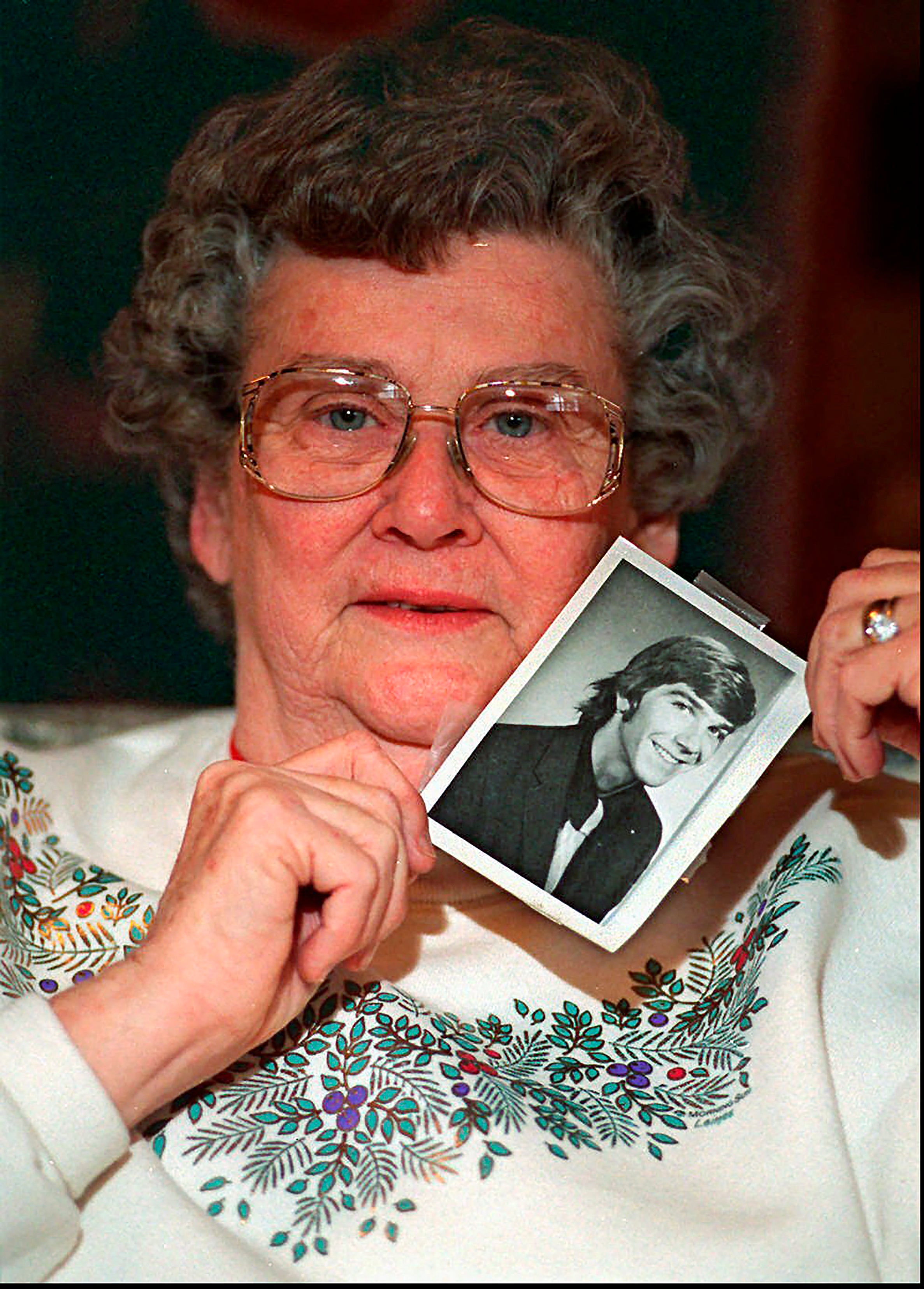 Kyle Clinkscales’ mother holds up a photo of her son, who went missing in 1976