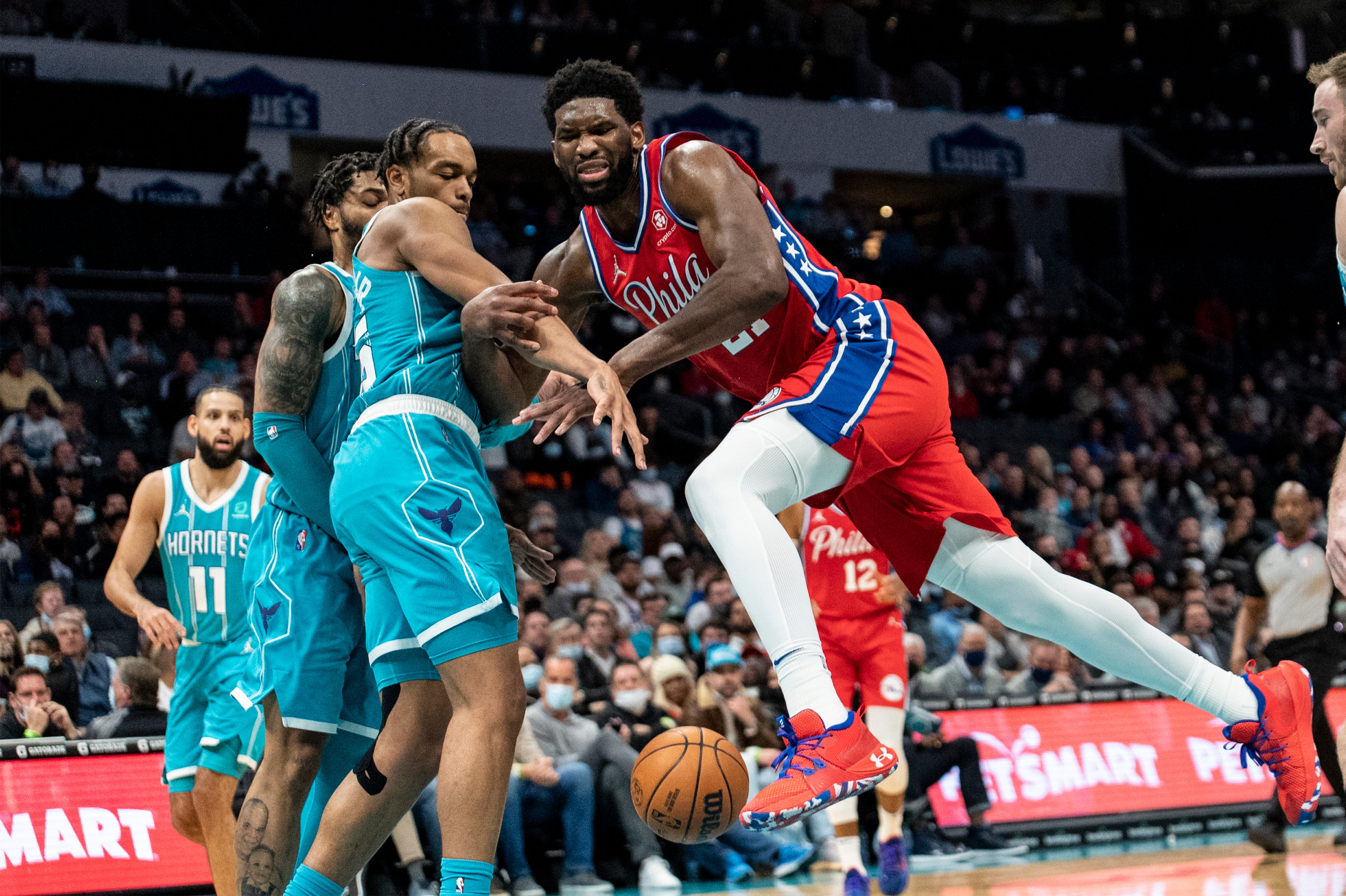 Philadelphia 76ers centre Joel Embiid (21) is fouled by Charlotte Hornets forward PJ Washington (AP Photo/Matt Kelley)