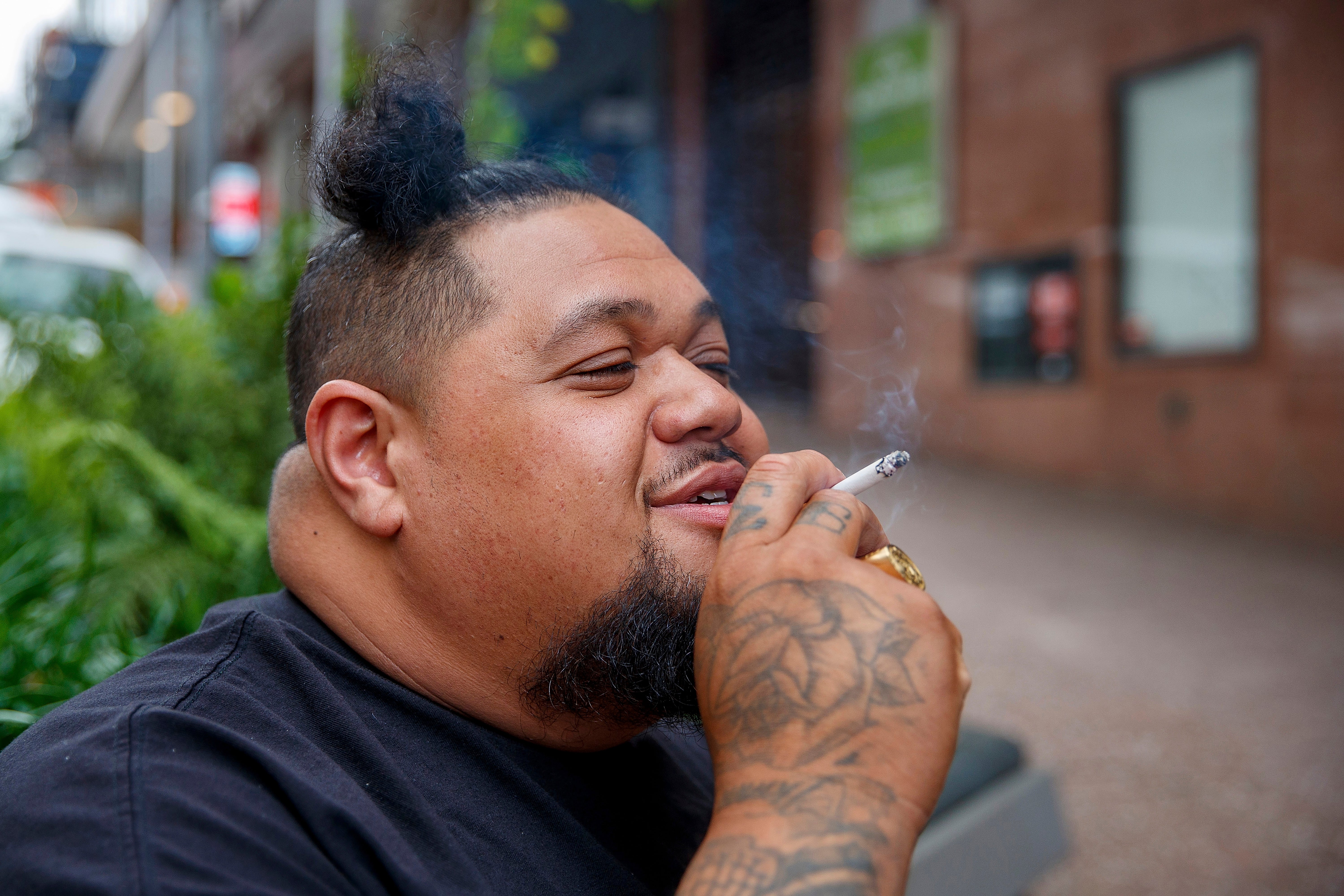 A man smoking on a street in Auckland