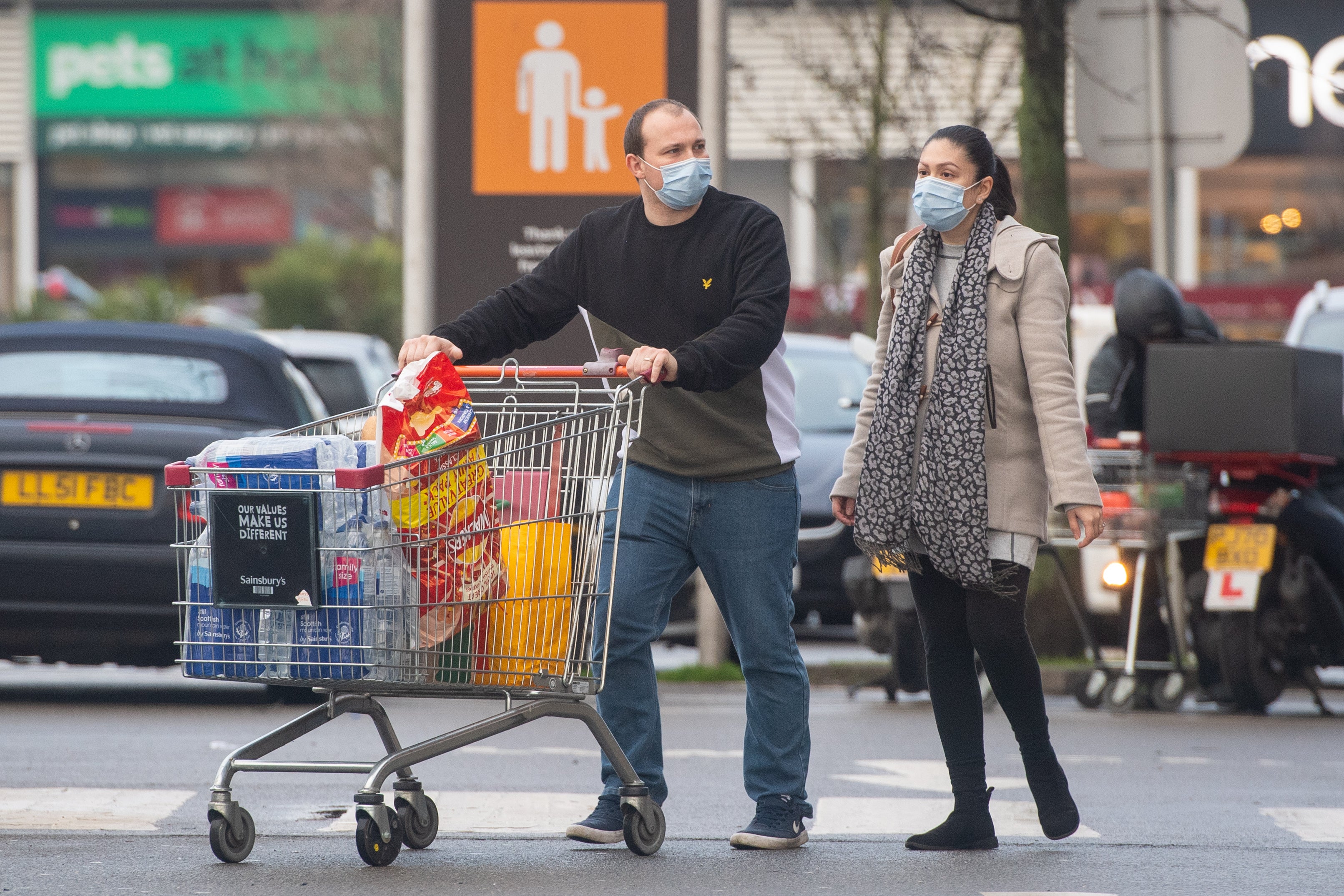 Shoppers wearing face masks outside a supermarket ( Dominic Lipinski/PA)