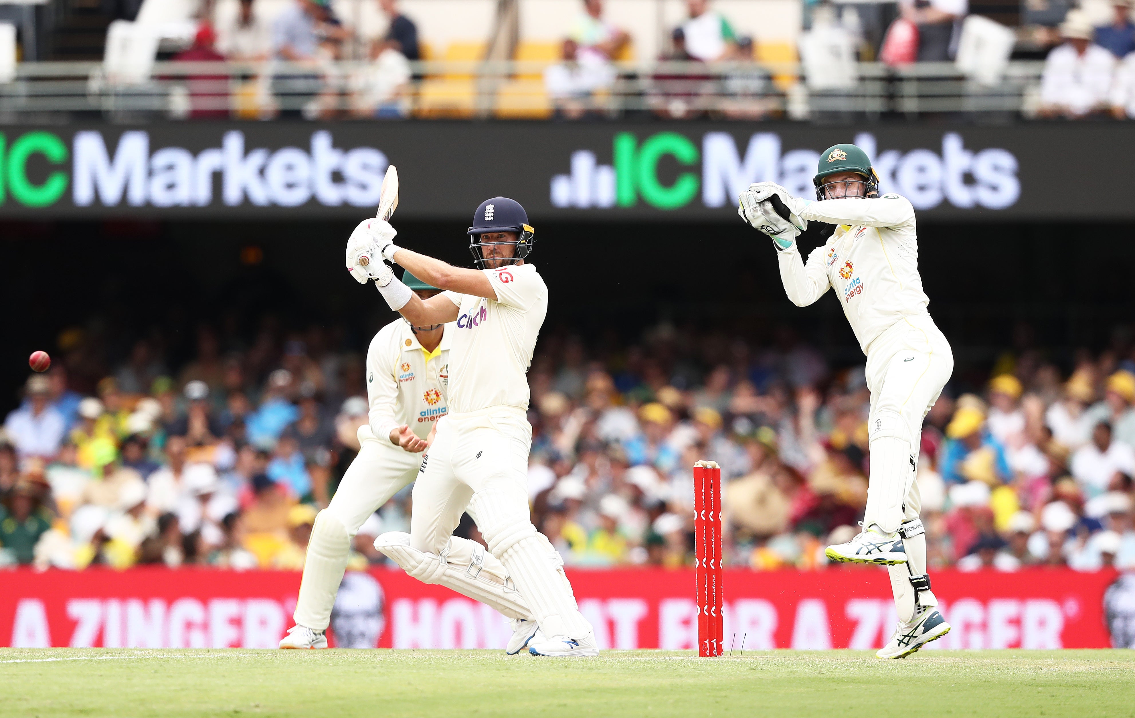 England’s Dawid Malan (left) plays a shot as Australia’s Alex Carey looks on during day three of the first Ashes test at The Gabba, Brisbane (Jason O’Brien/PA)