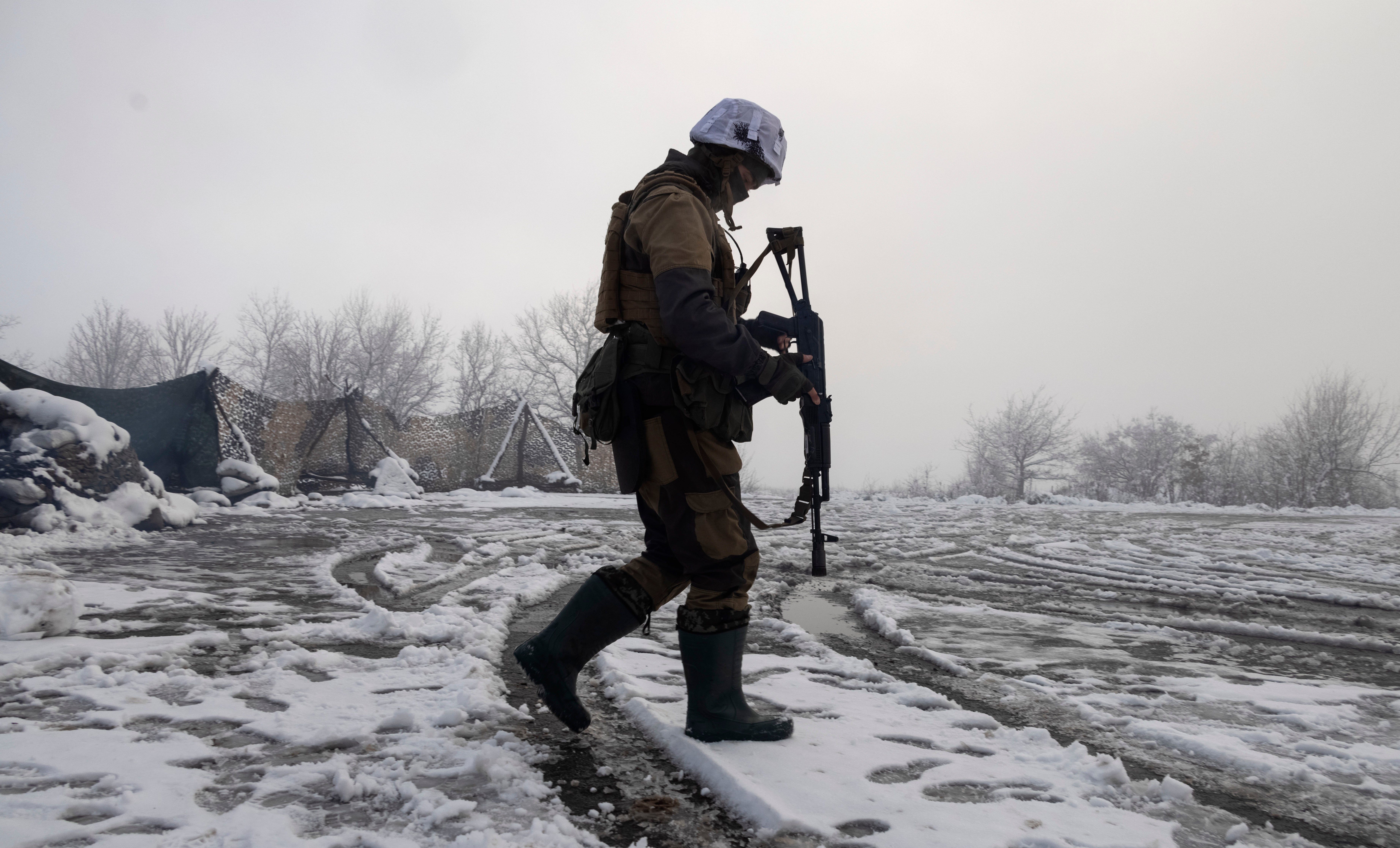 A Ukrainian soldier walks at the line of separation from pro-Russian rebels near Popasna, Donetsk region, Ukraine, Tuesday, 7 December 2021.