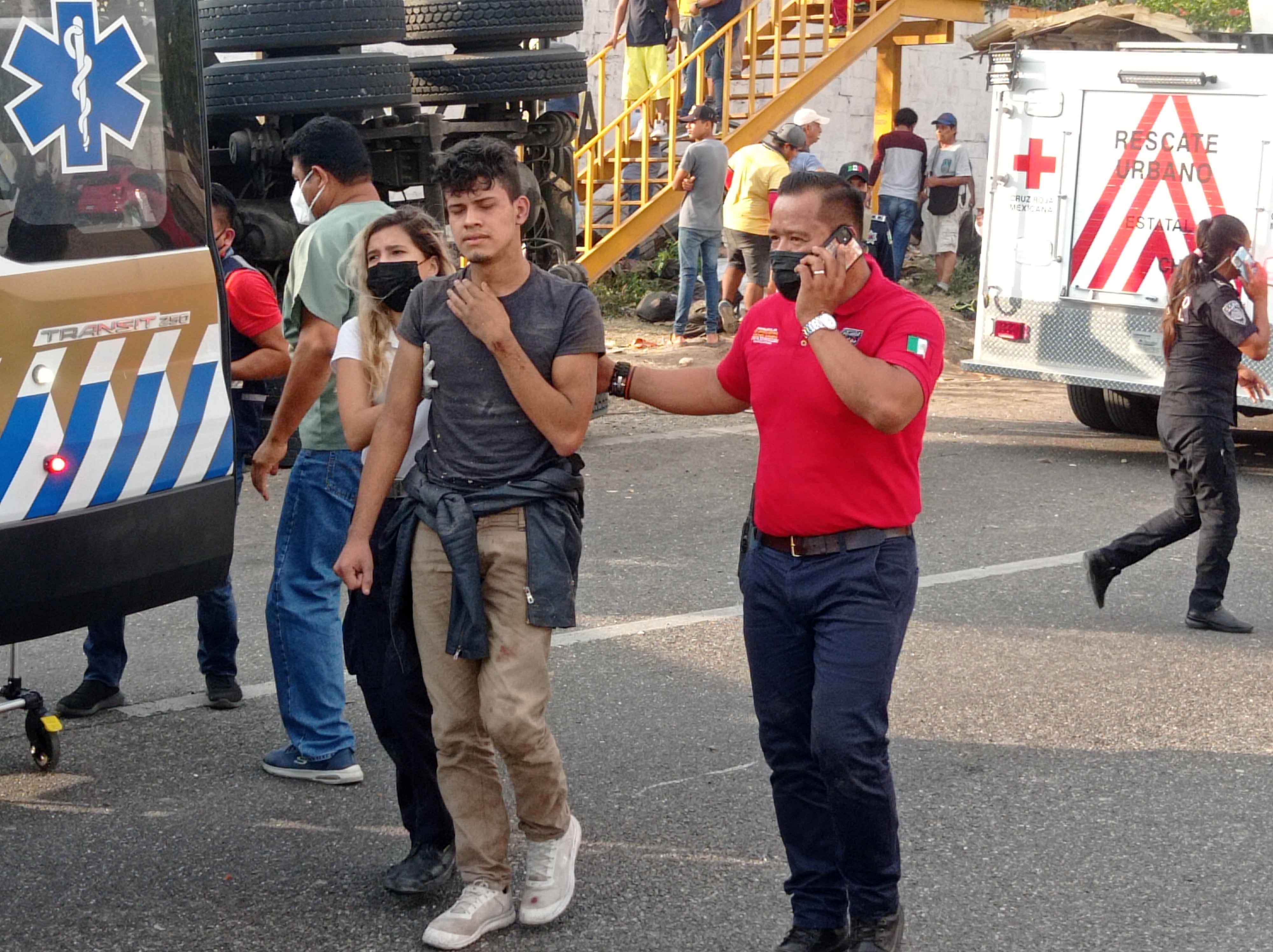 Emergency staff assist an injured man after the trailer crash