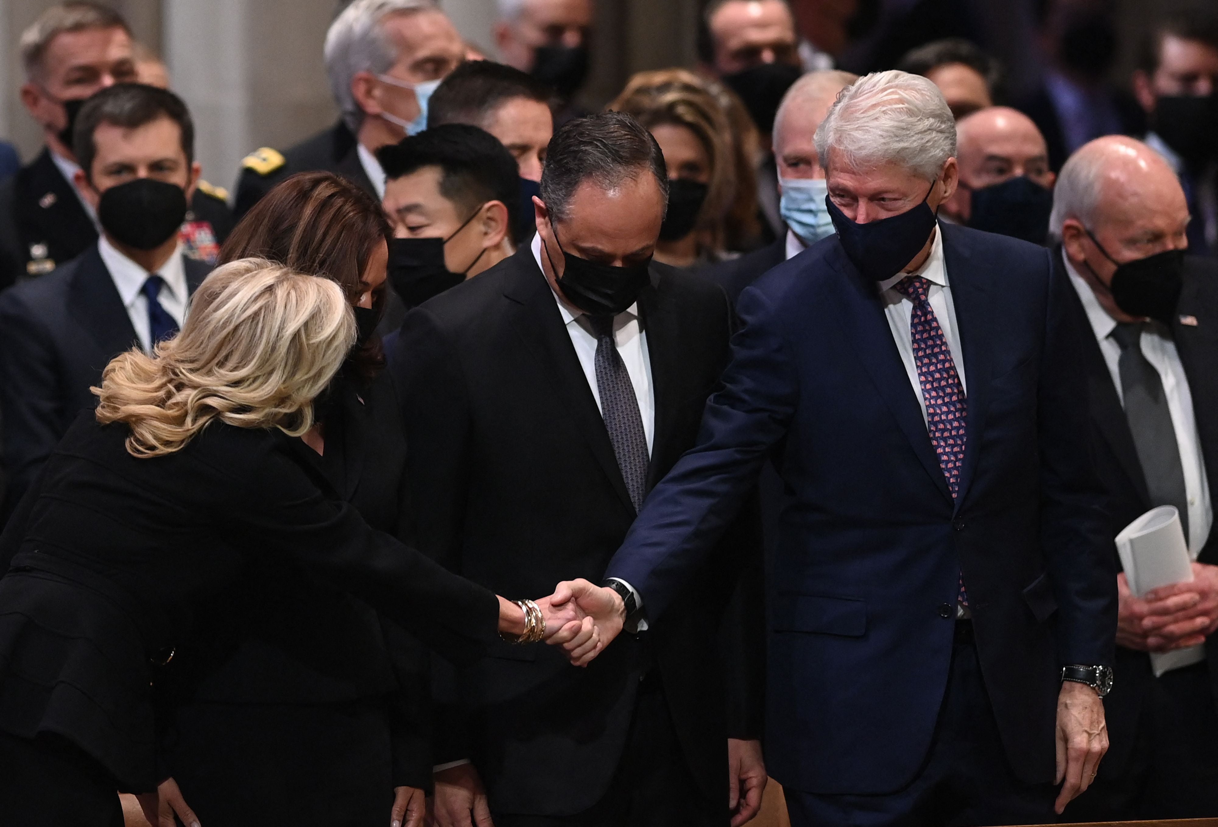 US First Lady Jill Biden greets former President Bill Clinton as they attend the funeral service for former US Senator Bob Dole at the Washington National Cathedral, on December 10, 2021, in Washington, DC.