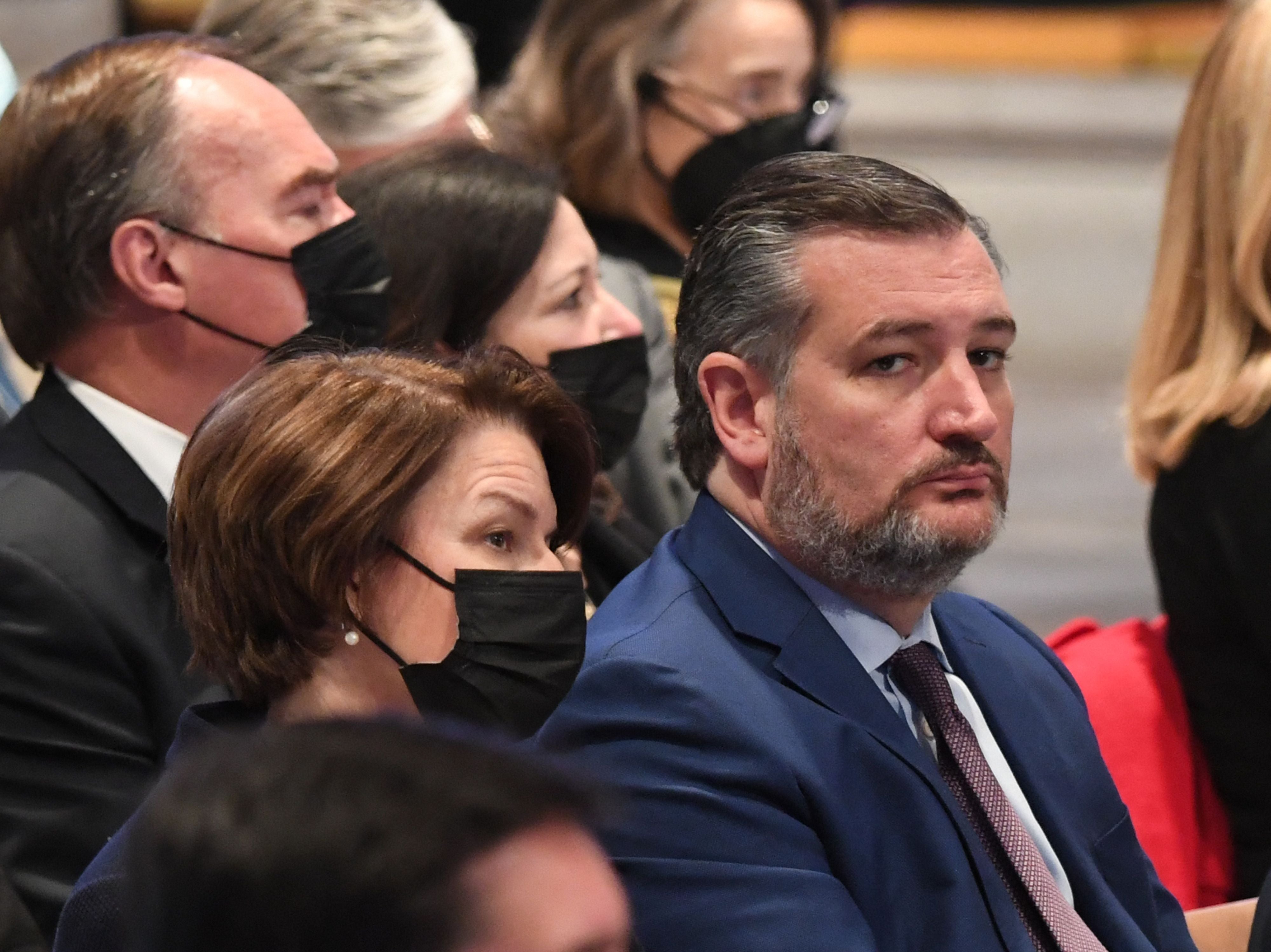 US senators Ted Cruz (R) and Amy Kobluchar attend the funeral service for former US Senator Bob Dole at the Washington National Cathedral, on December 10, 2021, in Washington, DC.