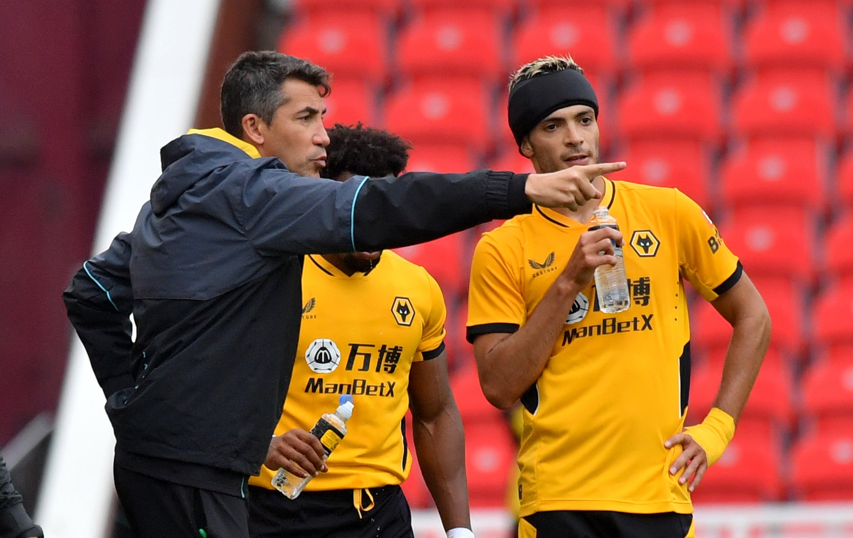 Bruno Lage, left, gives instructions to Raul Jimenez on the sideline (Anthony Devlin/PA)