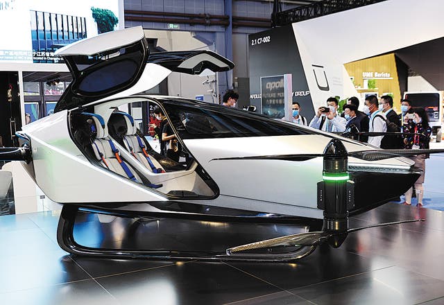 <p>Visitors look over the X2 flying car, produced by Chinese company XPeng, that is on display at the China International Import Expo held in Shanghai in November</p>