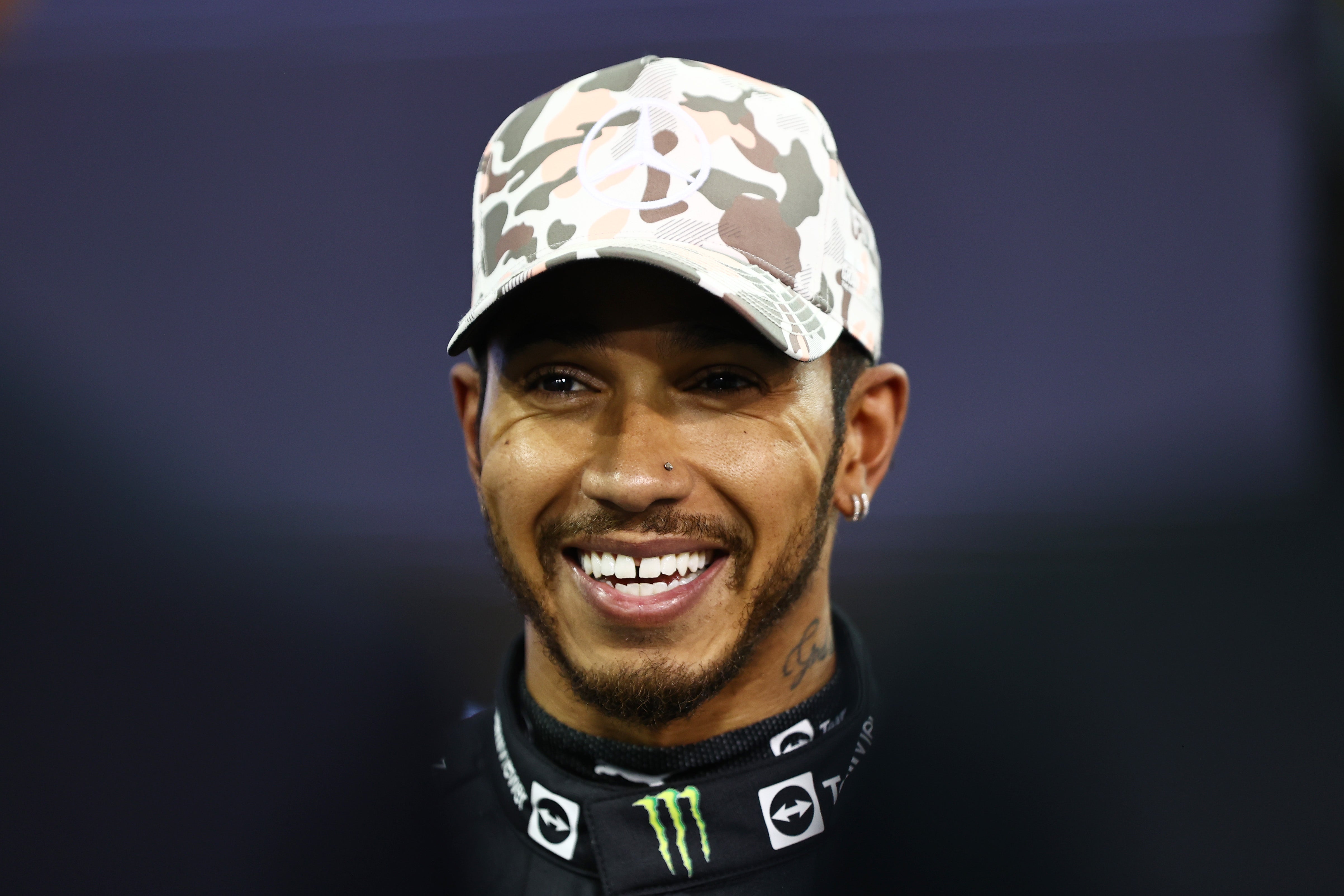 Lewis Hamilton looks on in parc ferme at the Grand Prix of Abu Dhabi at Yas Marina Circuit