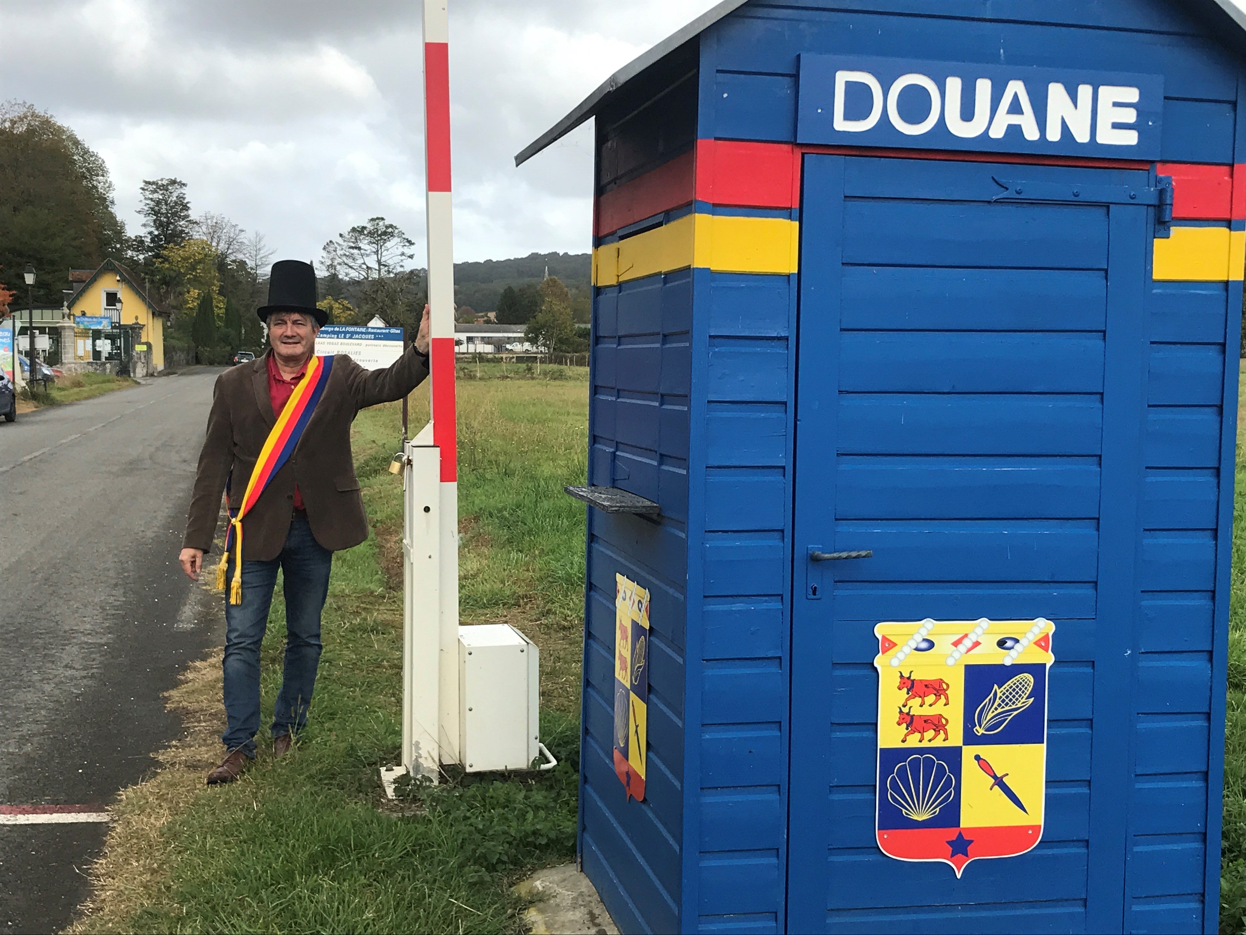 Laas mayor Jacques Pedehontaa poses at the entrance to his self-declared principality