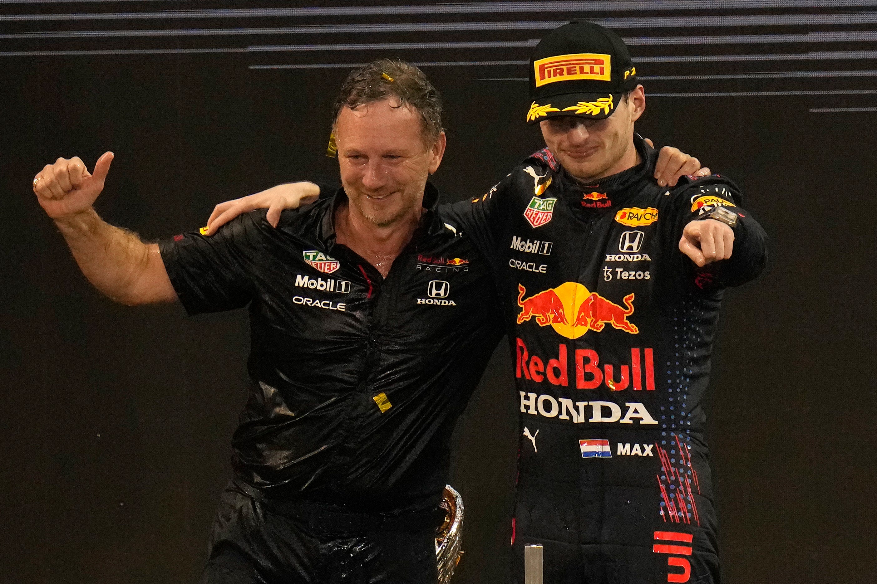 Christian Horner (left) celebrated with Max Verstappen (Hassan Ammar/AP)