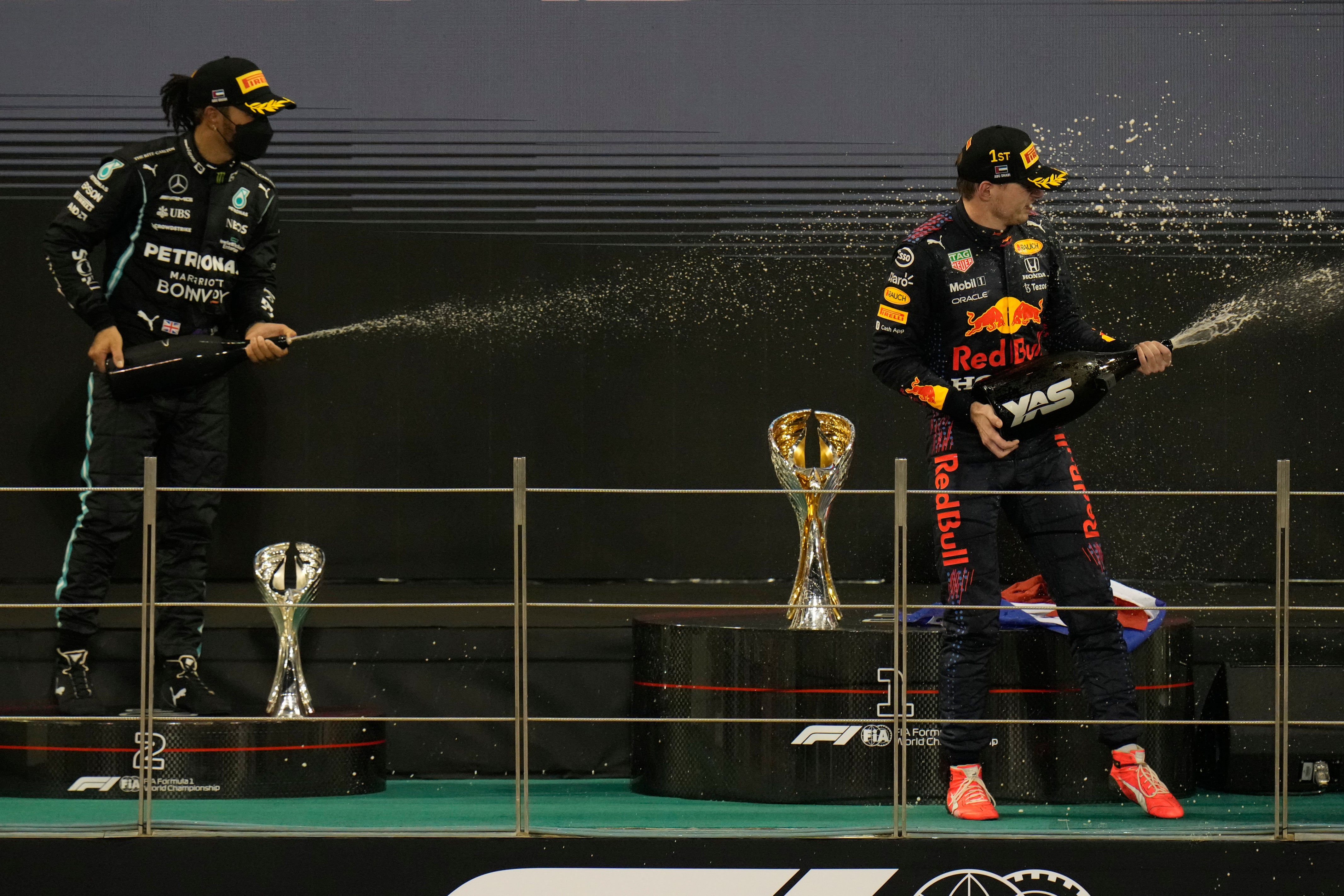 Max Verstappen (right) battled against Lewis Hamilton (left) until the last lap of the 22-race season (Hassan Ammar/AP)