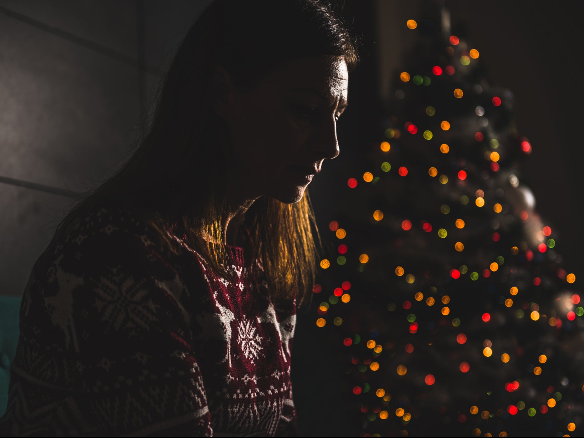 A woman sits alone on Christmas Day