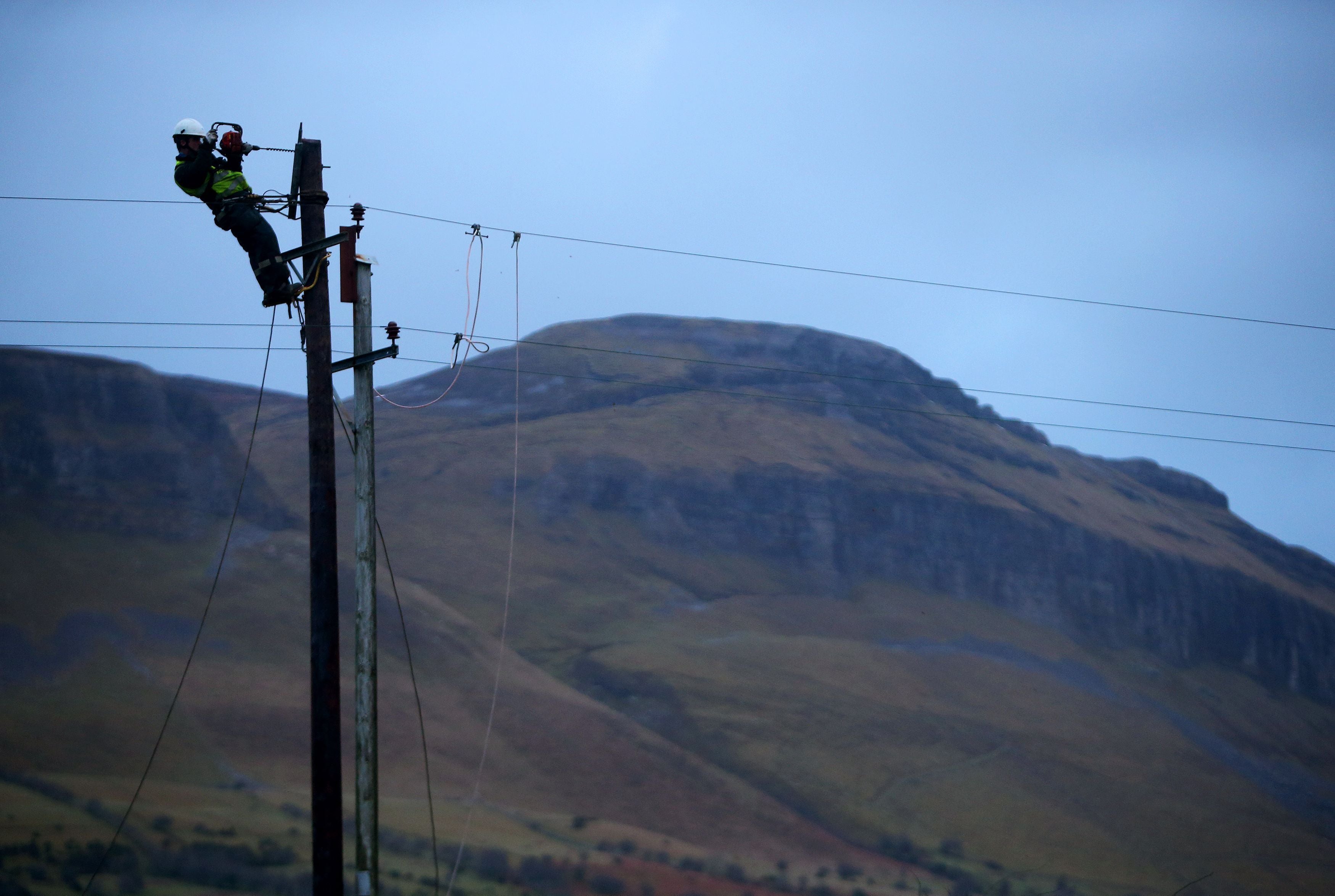 An ESB worker works on a telegraph pole (Brian Lawless/PA)