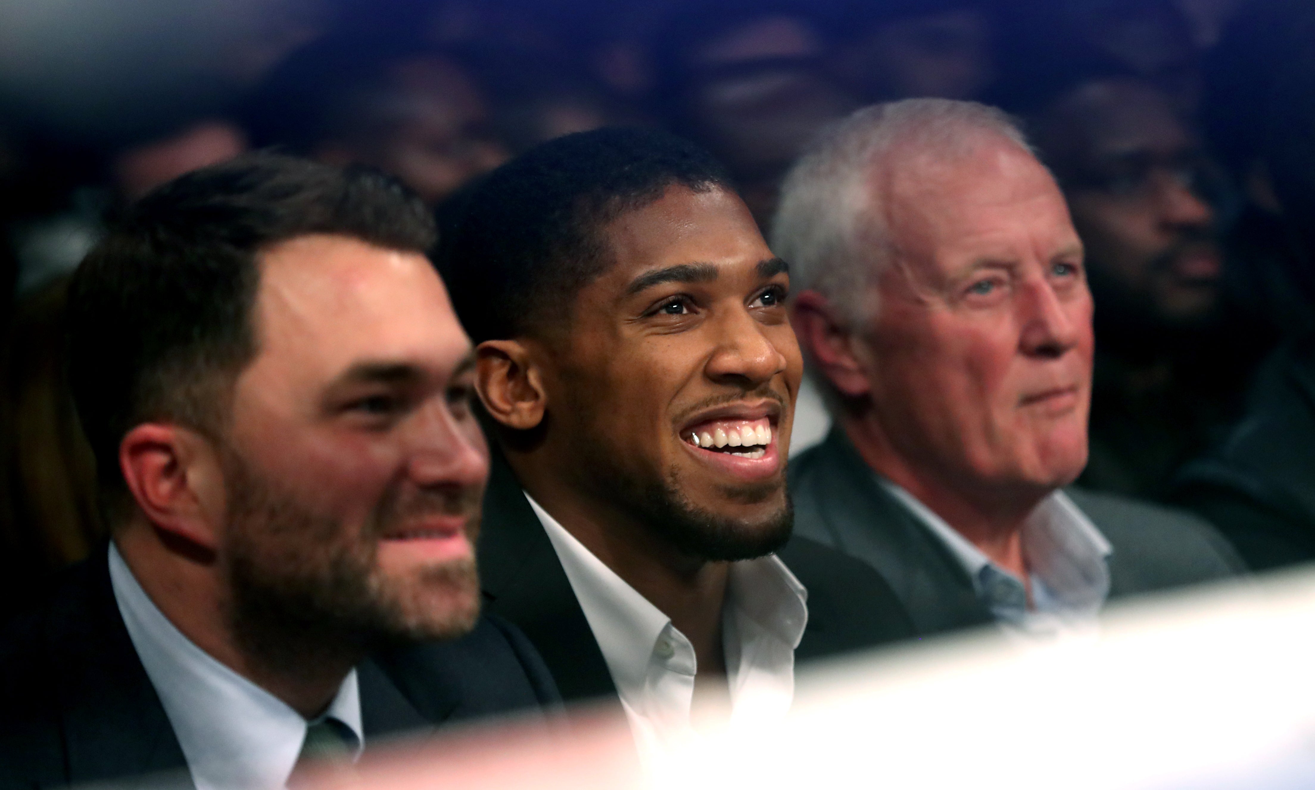 Eddie Hearn, left, Anthony Joshua, centre, and Barry Hearn in the audience at The O2 Arena in London