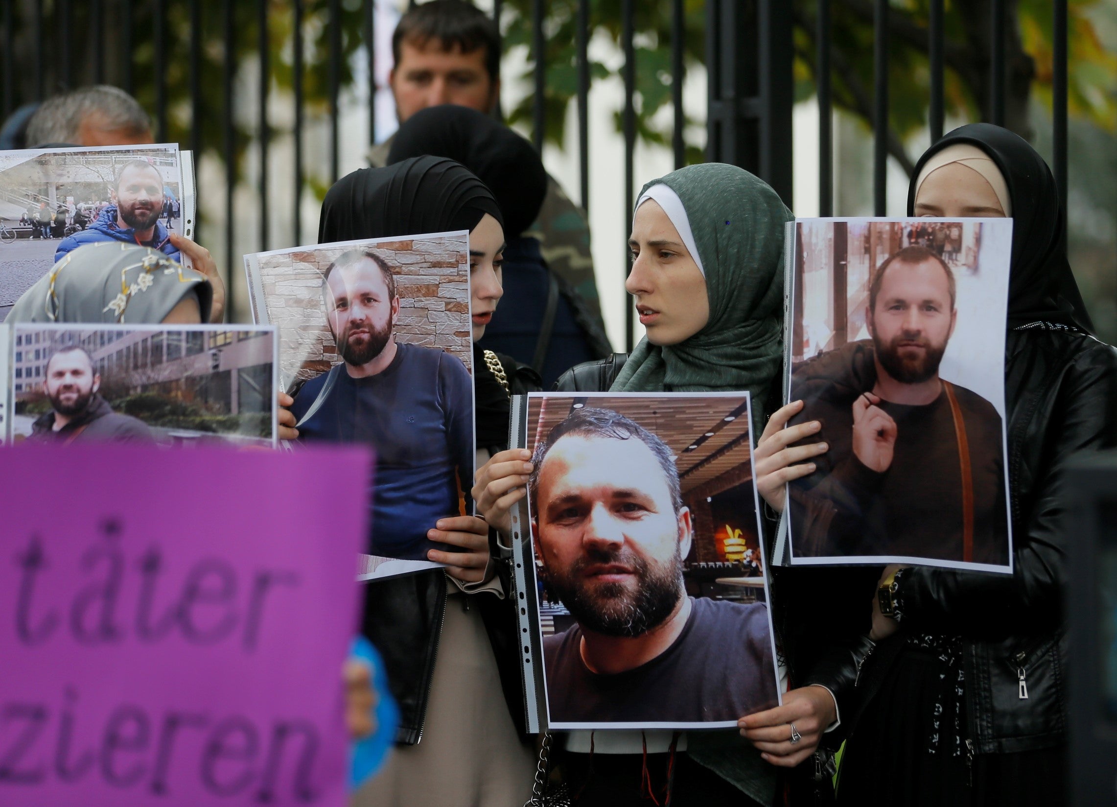 File photo: People hold portraits of Zelimkhan Khangoshvili in front of the German embassy in Tbilisi, Georgia, in 2019