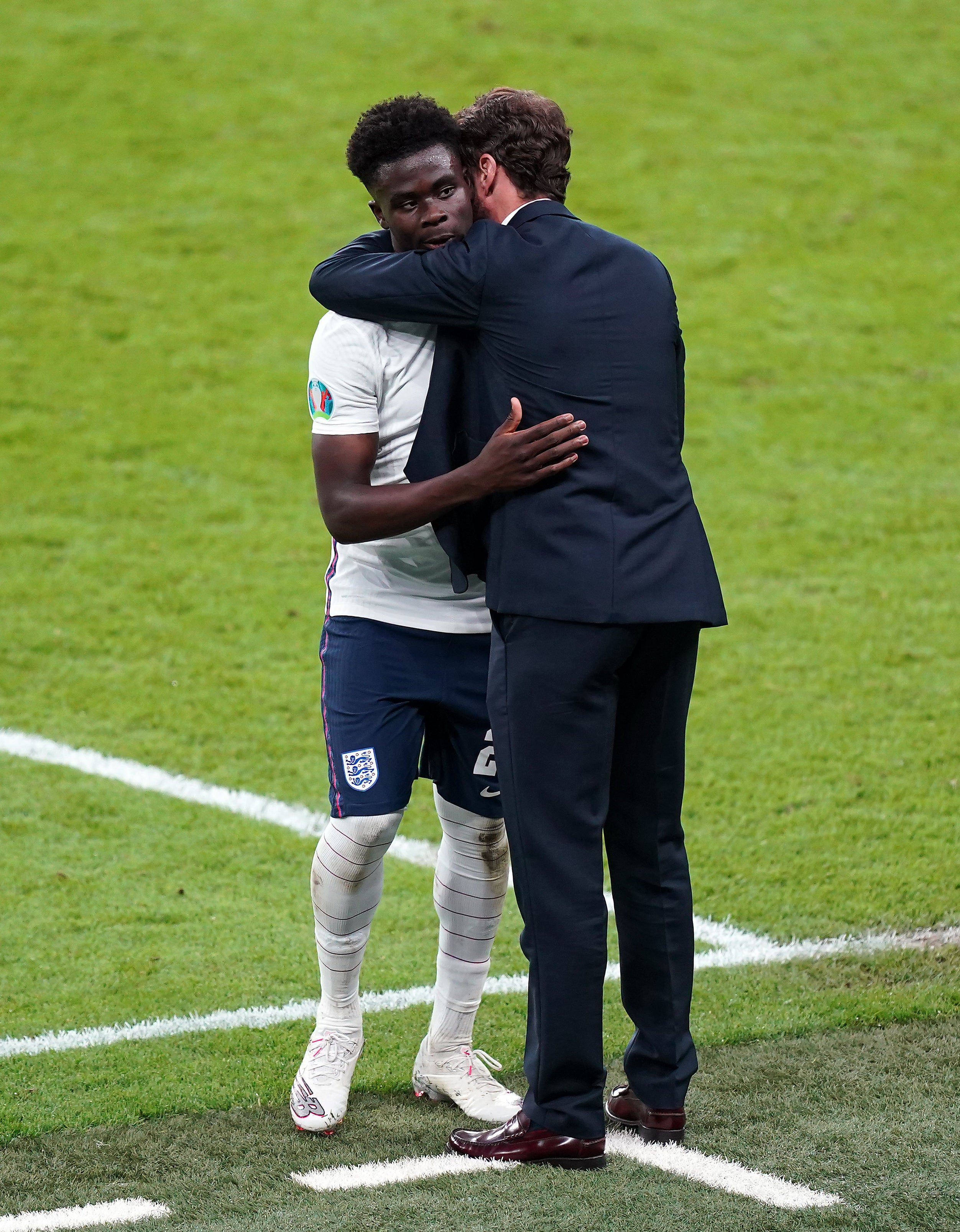 England manager Gareth Southgate consoles Bukayo Saka after his Euro 2020 final shootout miss (Mike Egerton/PA)