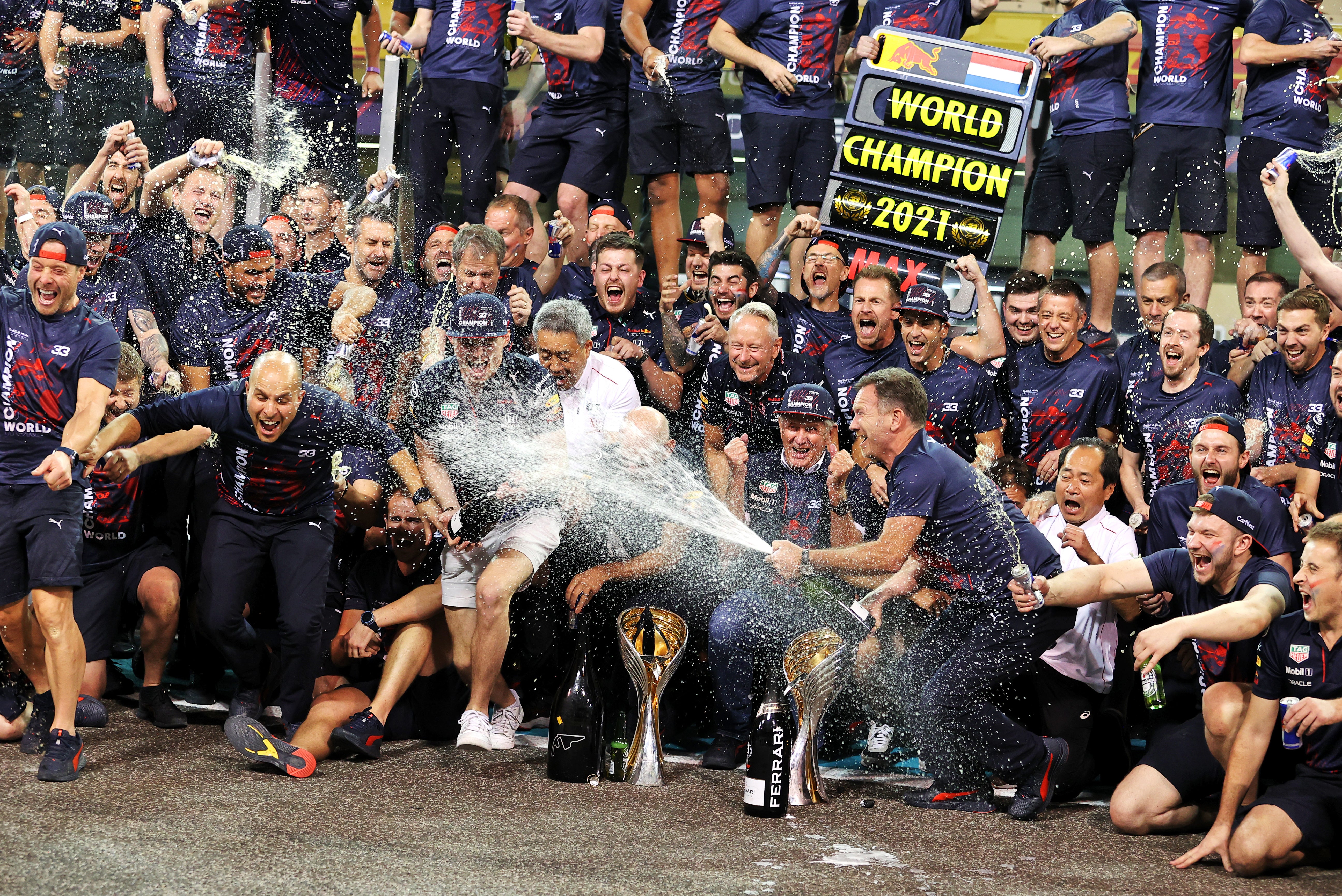 Max Verstappen (centre) clinched his maiden Formula One title on an exciting last lap of the season