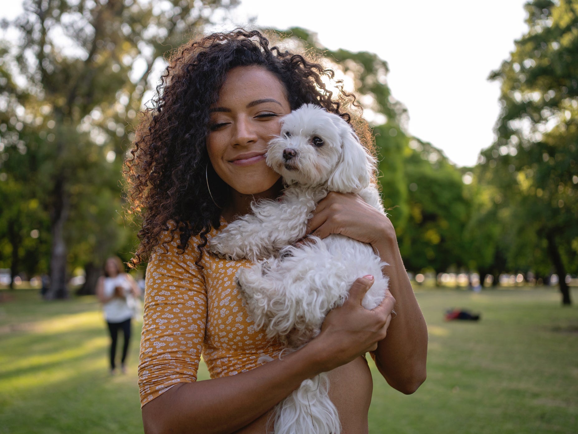 A woman at the park with her dog