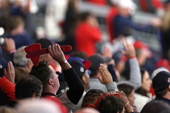 Fans doing the "tomahawk chop" gesture at an Atlanta Braves baseball game