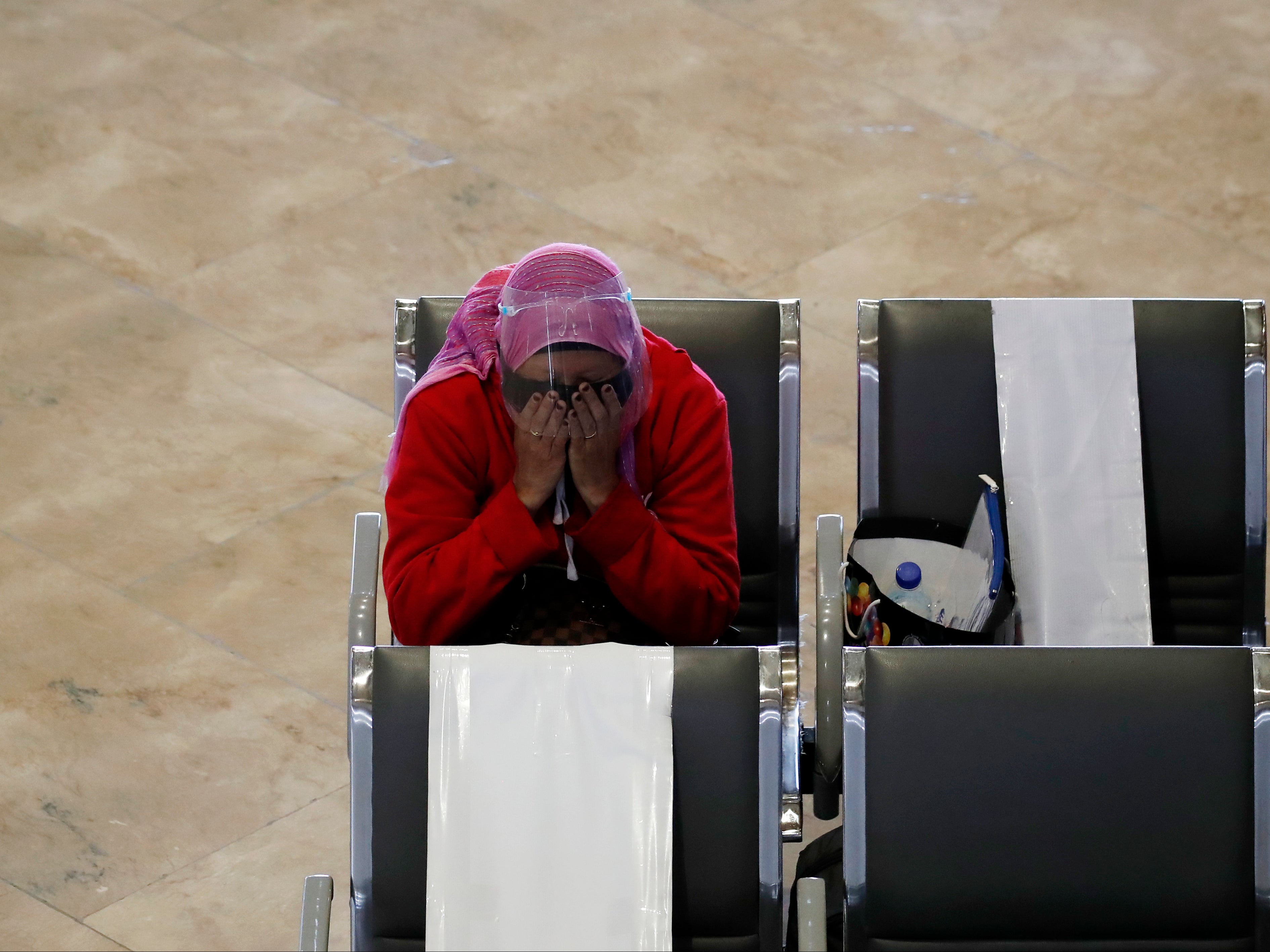 A Filipino migrant worker sits at Manila’s international airport earlier in the year