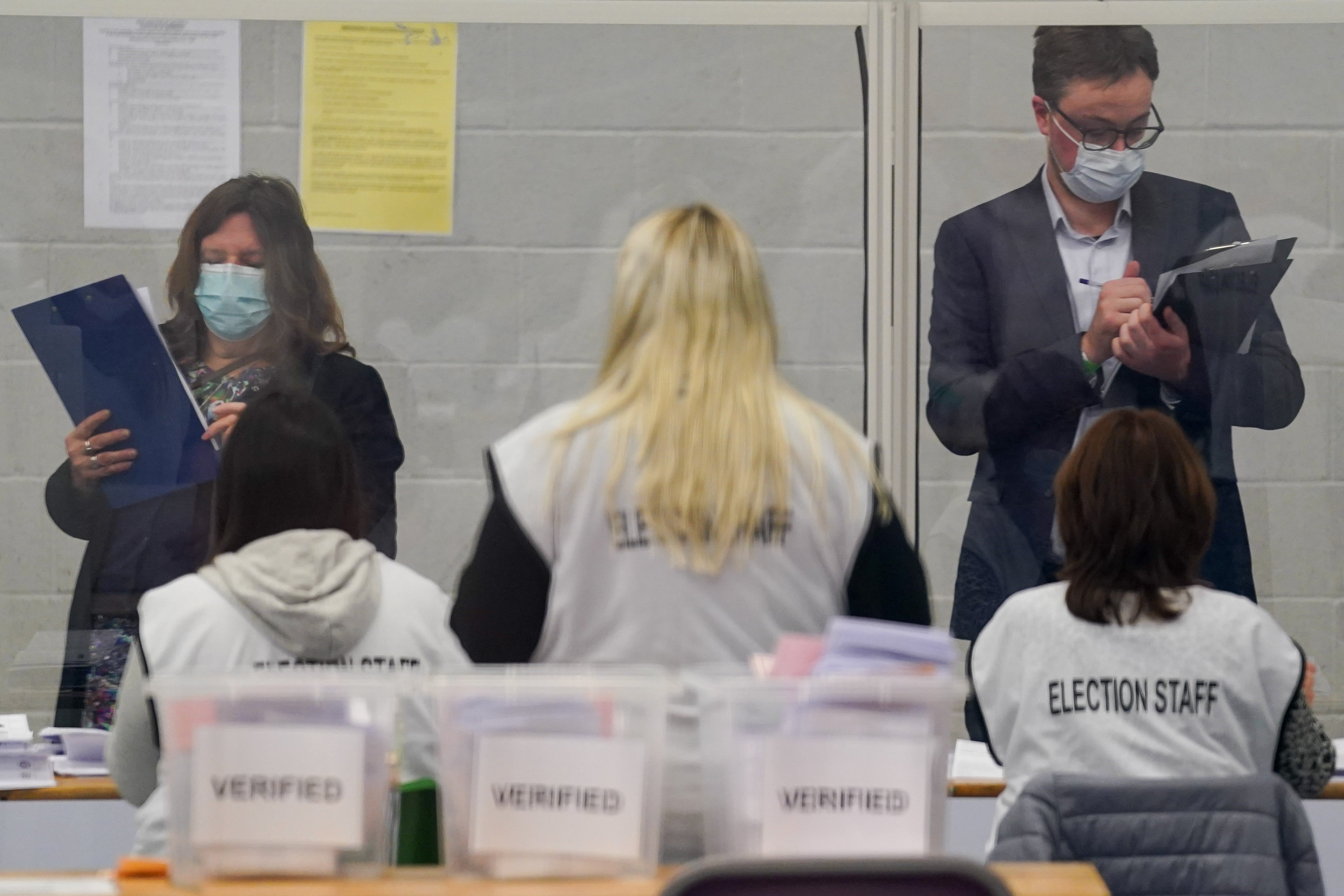 Observers watch election staff sorting votes during the count for the North Shropshire by-election at Shrewsbury Sports Village (Jacob King/PA)