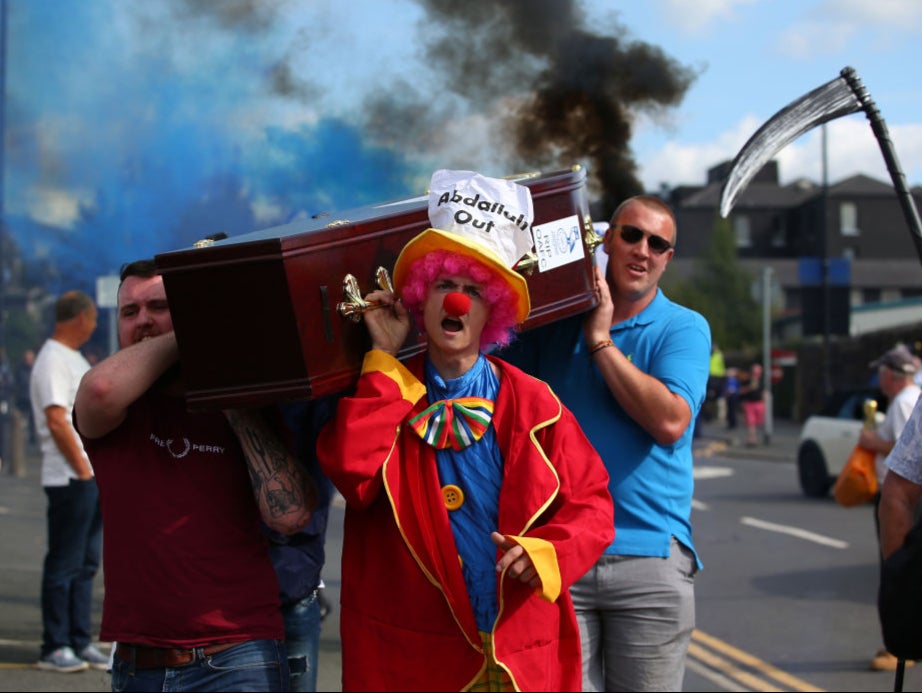 Oldham fans carry a coffin outside the stadium in protest against Lemsagem