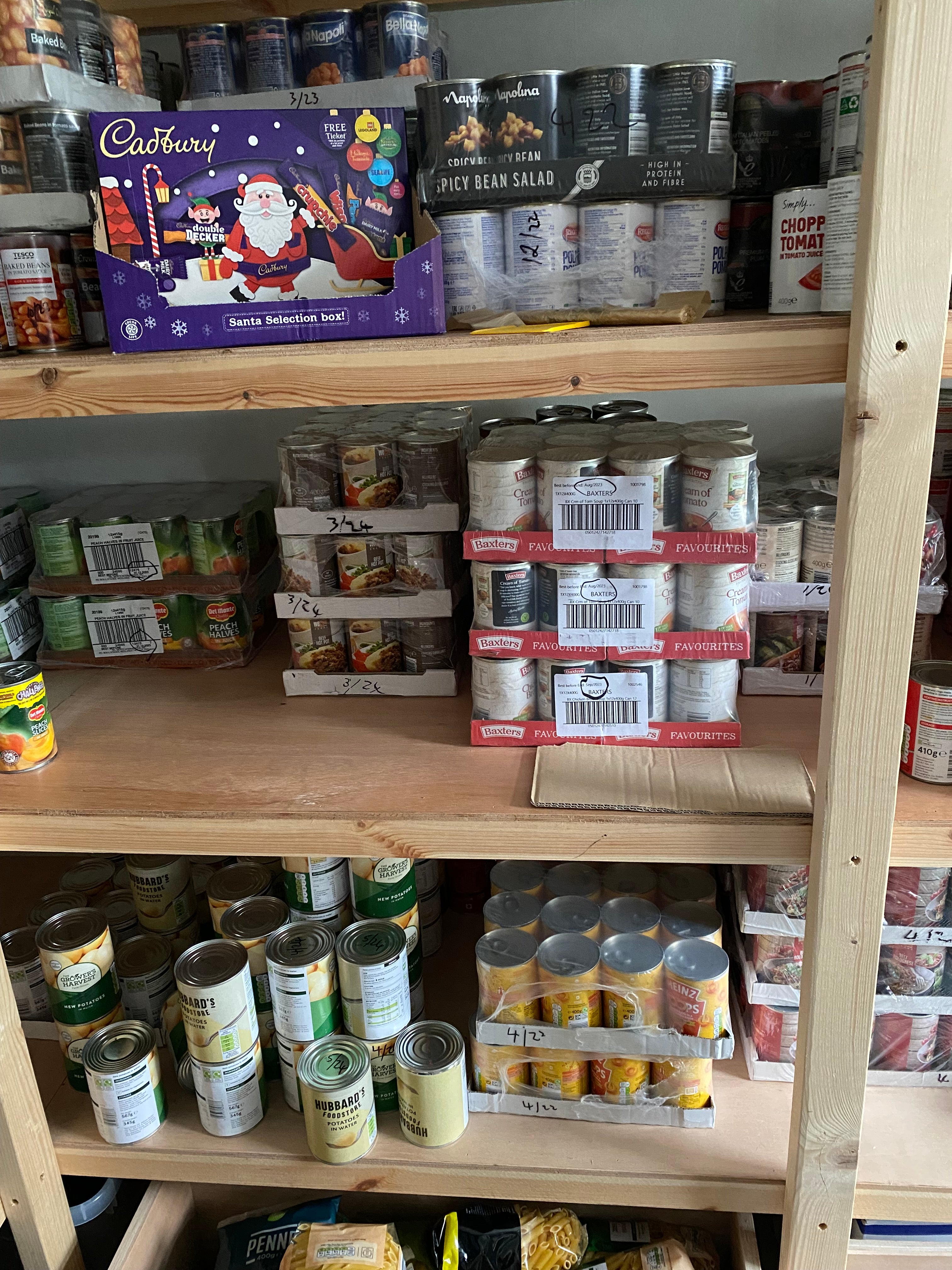 Shelved food awaiting distribution at the food bank run by the Pontarddulais Partnership (Catherine Evans/PA)