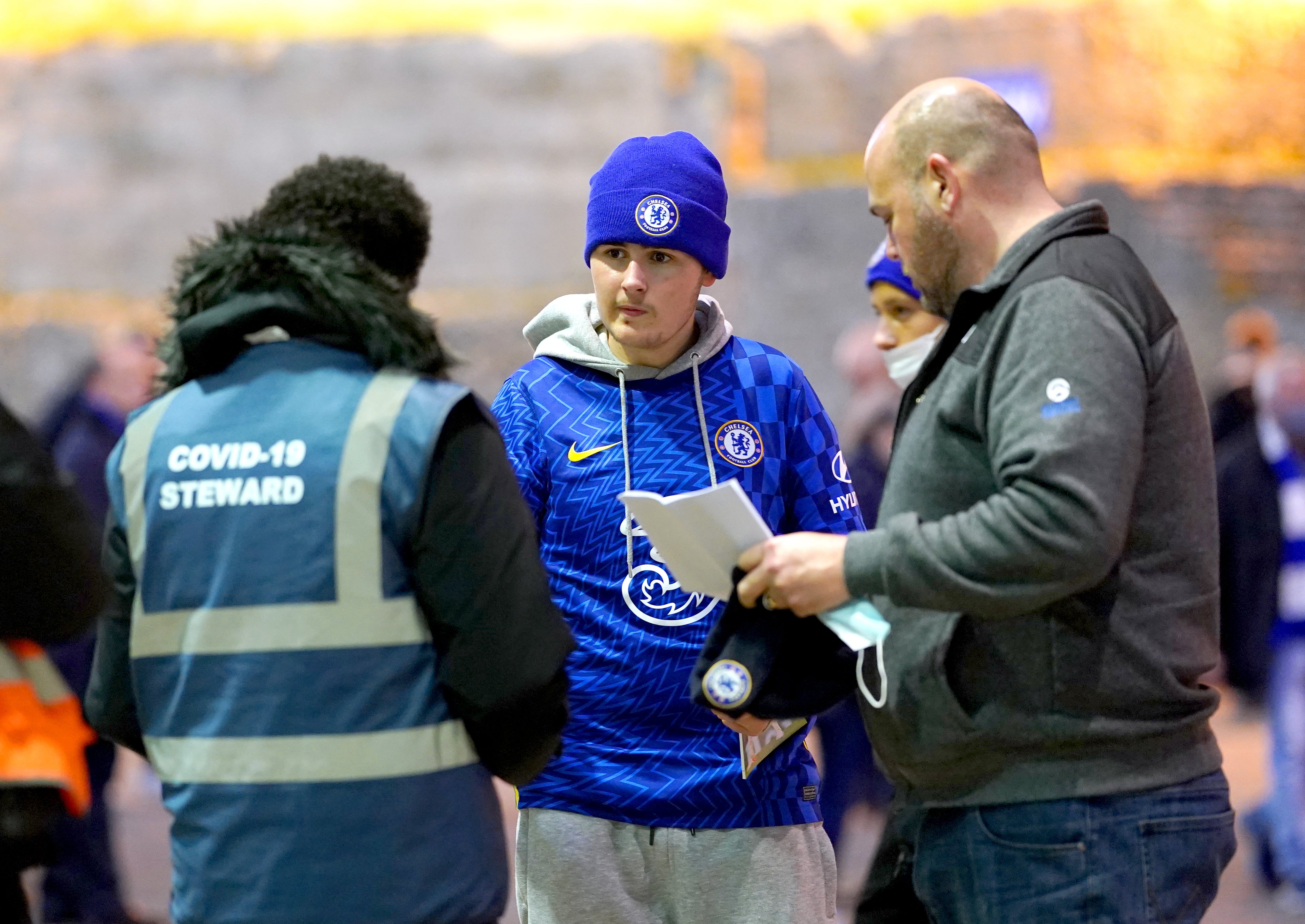 A Chelsea fan shows a Covid pass to a steward ahead of the Premier League match at Stamford Bridge in London (Adam Davy/PA)