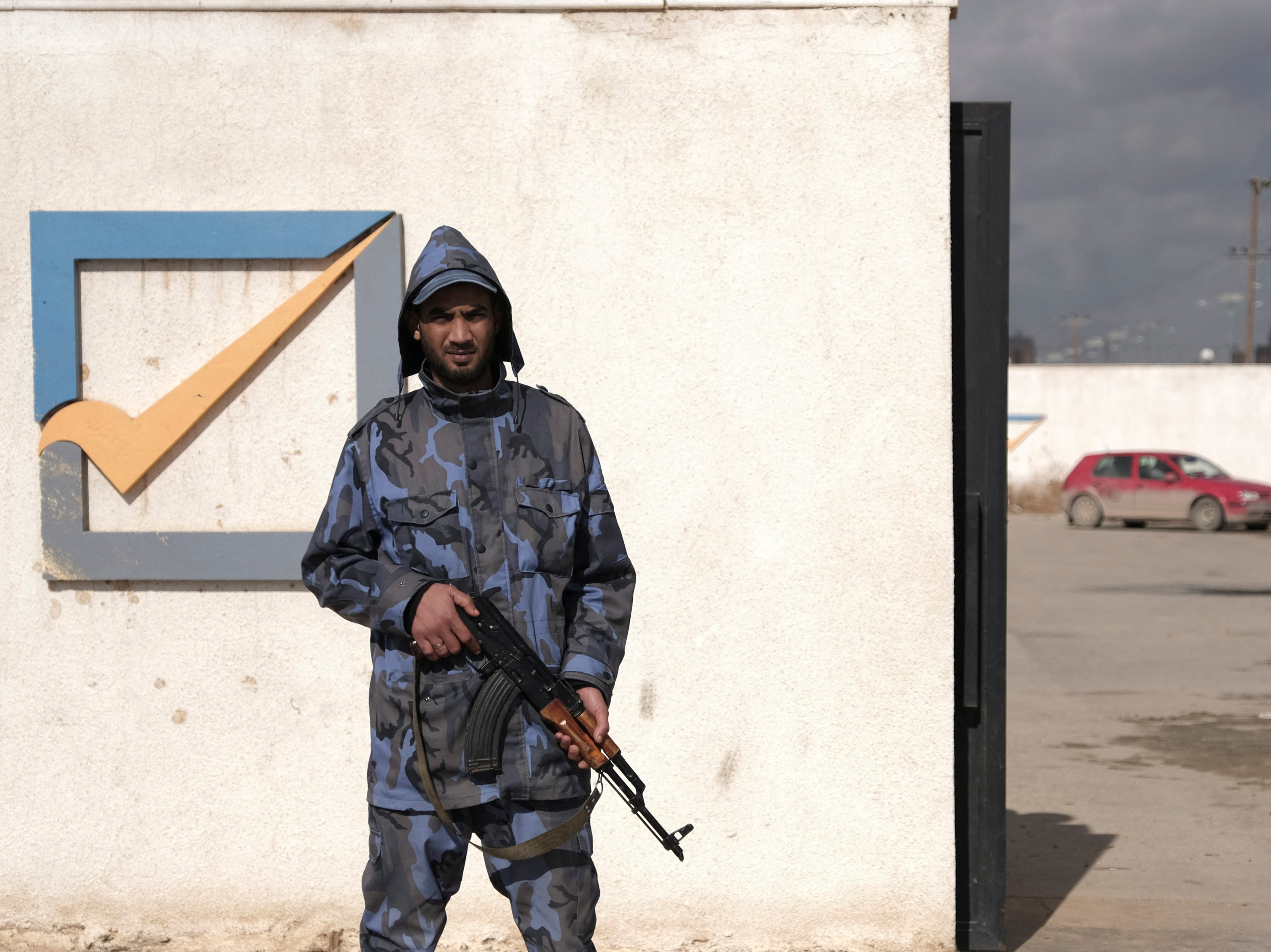 A security officer stands in front of the High National Election Commission building in Benghazi this week