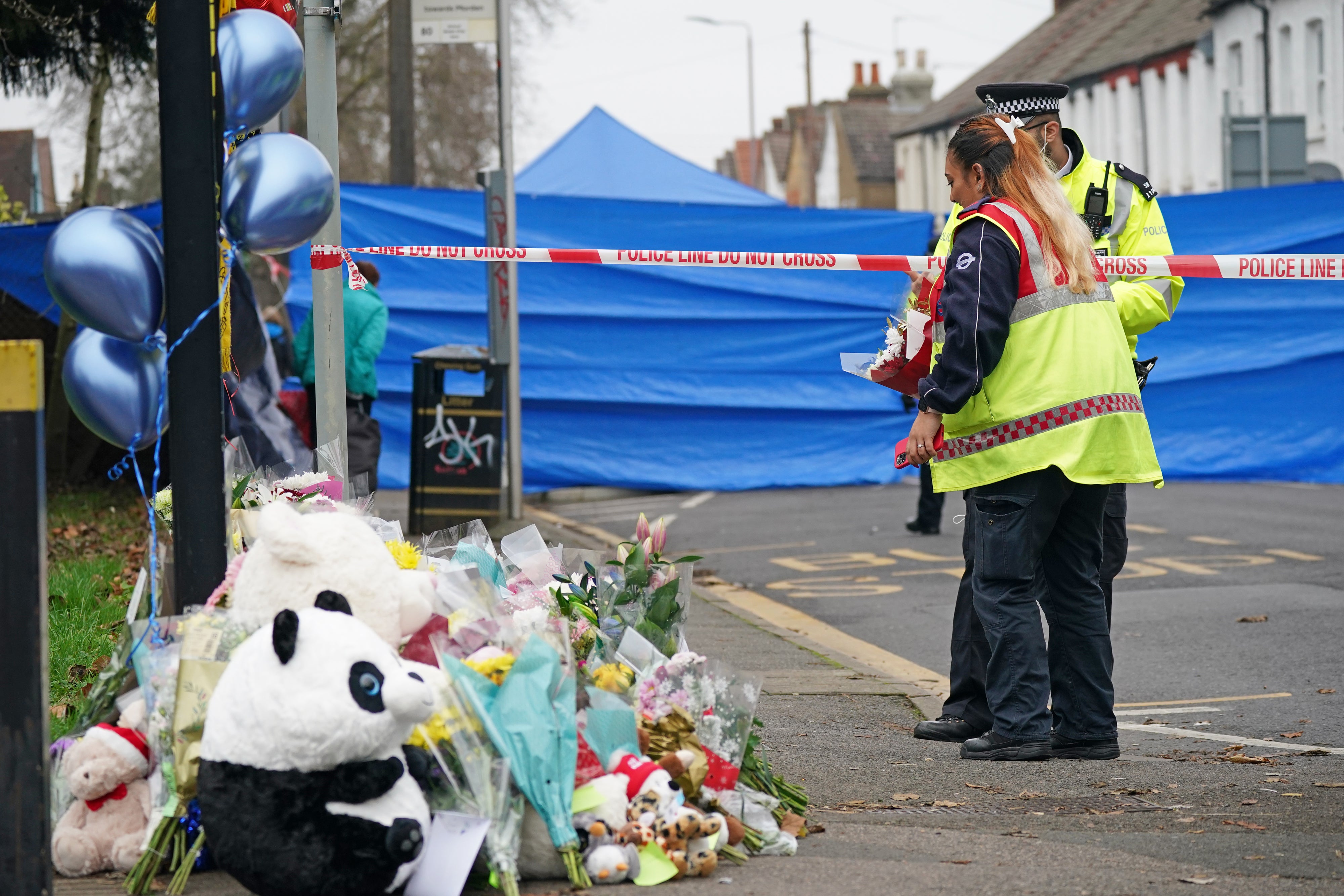 People lay flowers near the scene in Sutton, south London (Yui Mok/PA)