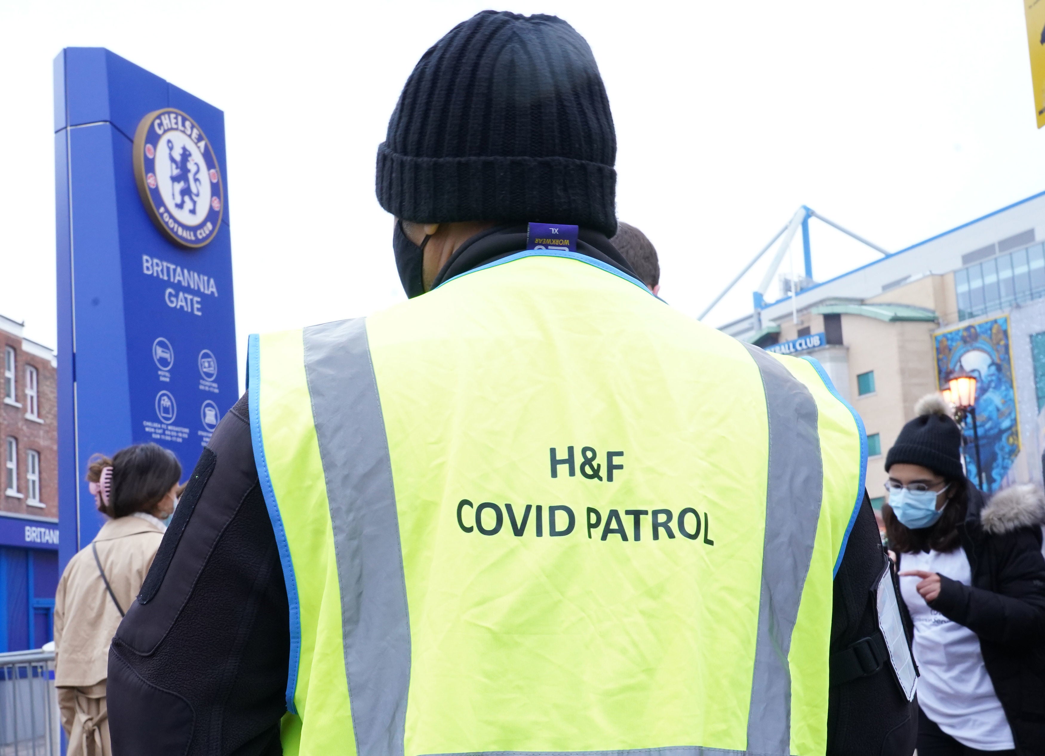 People queue at a vaccination centre at Stamford Bridge football stadium in London (Ian West/PA)