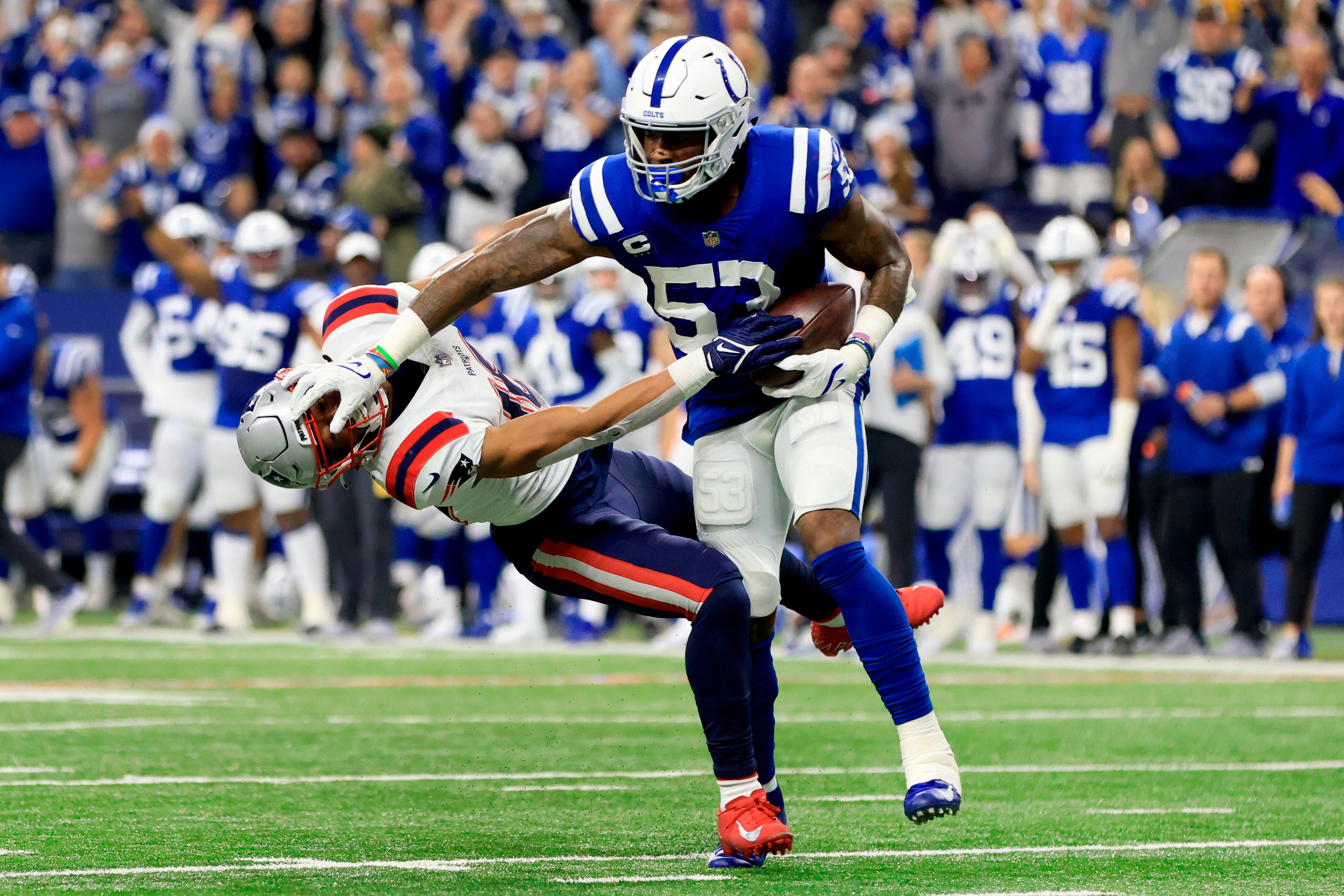 Indianapolis Colts linebacker Darius Leonard pushes away New England Patriots wide receiver Jakobi Meyers after intercepting a pass (Aaron Doster/AP)