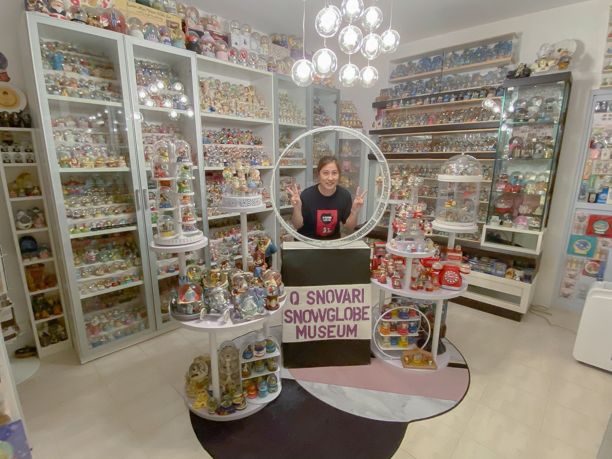 Wendy Suen with all of her snow globes