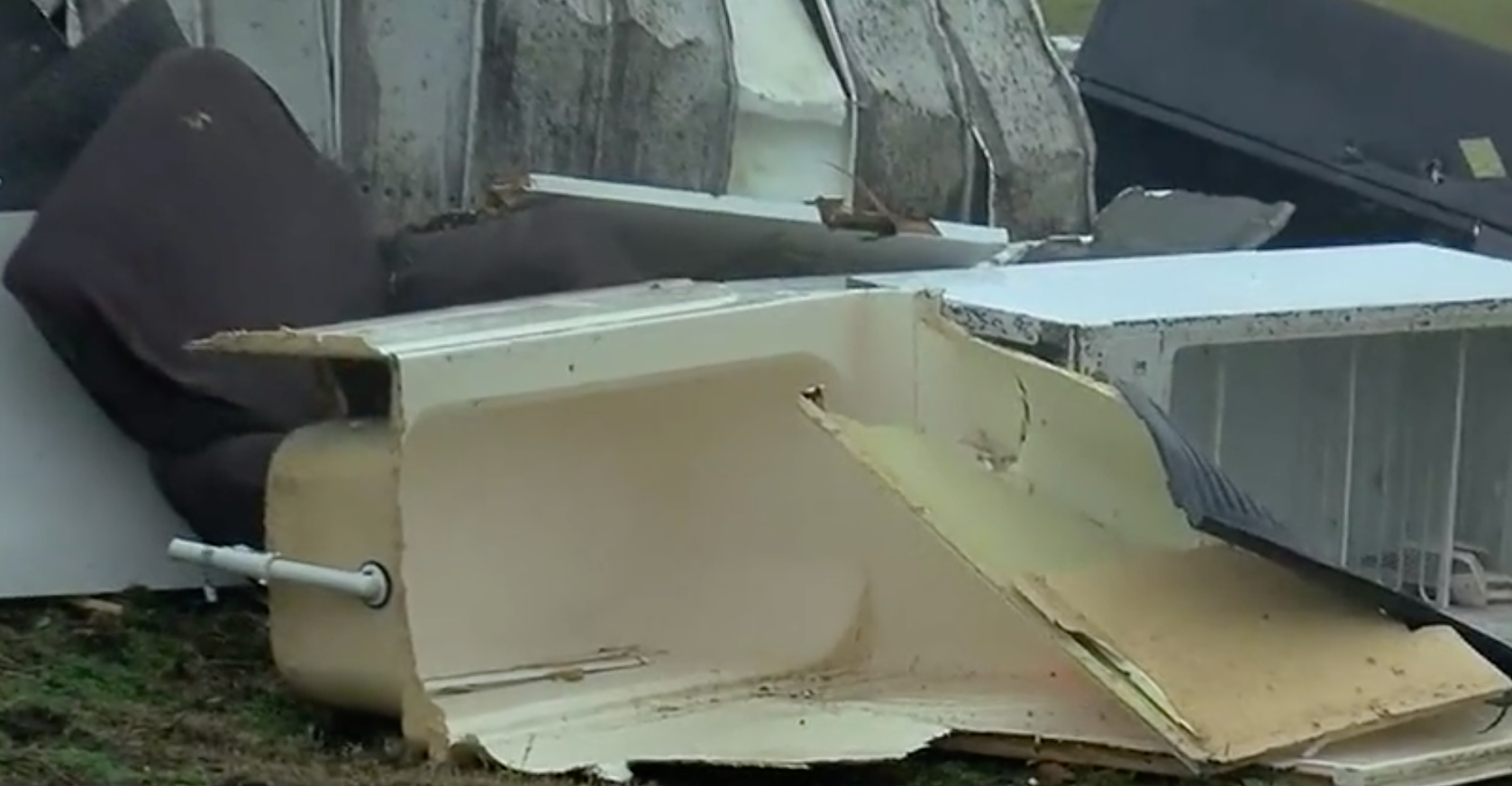 After the tornado passed, rescuers discovered the tub in the yard upside down