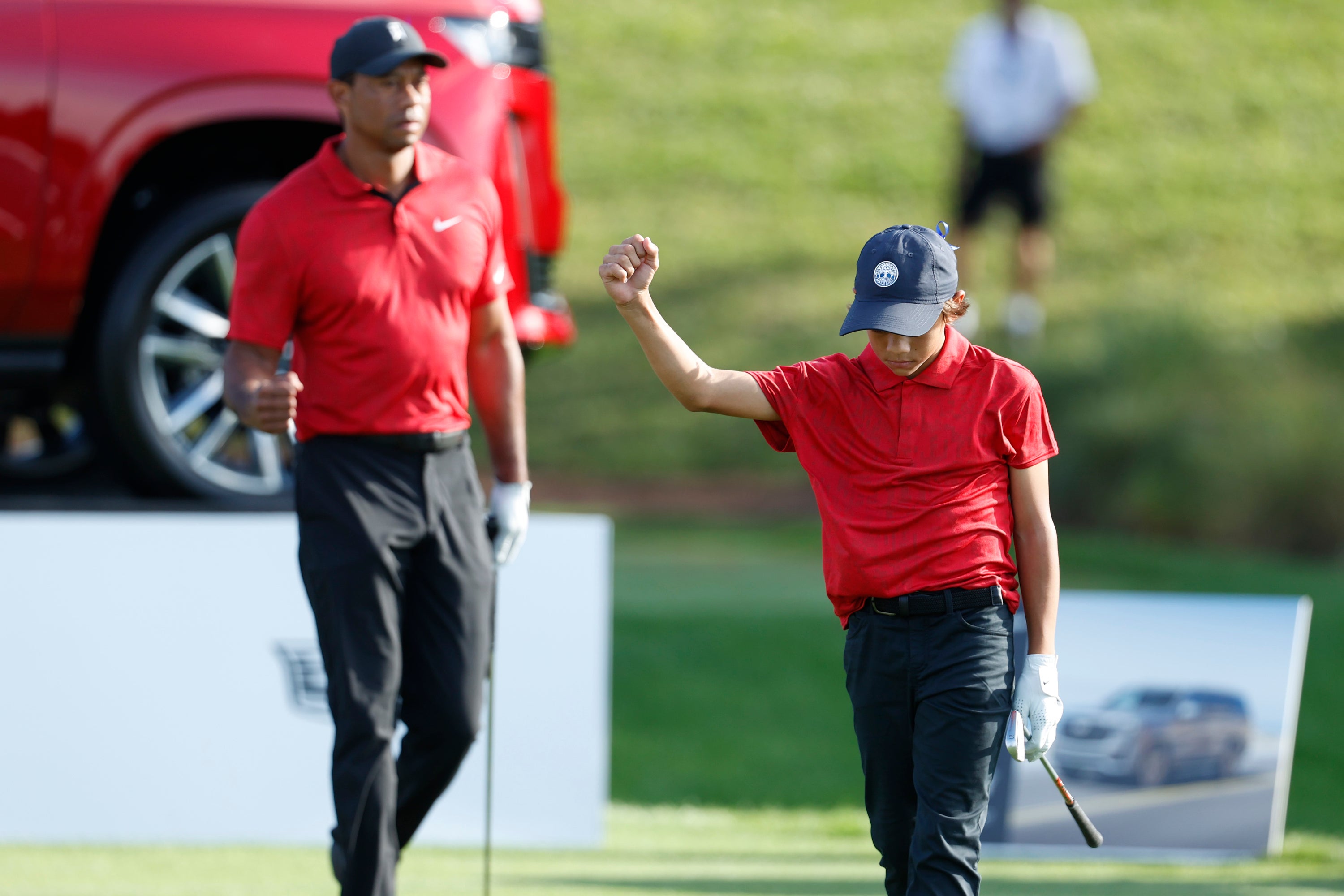 Charlie and Tiger Woods, left, at the PNC Championship (Scott Audette/AP)