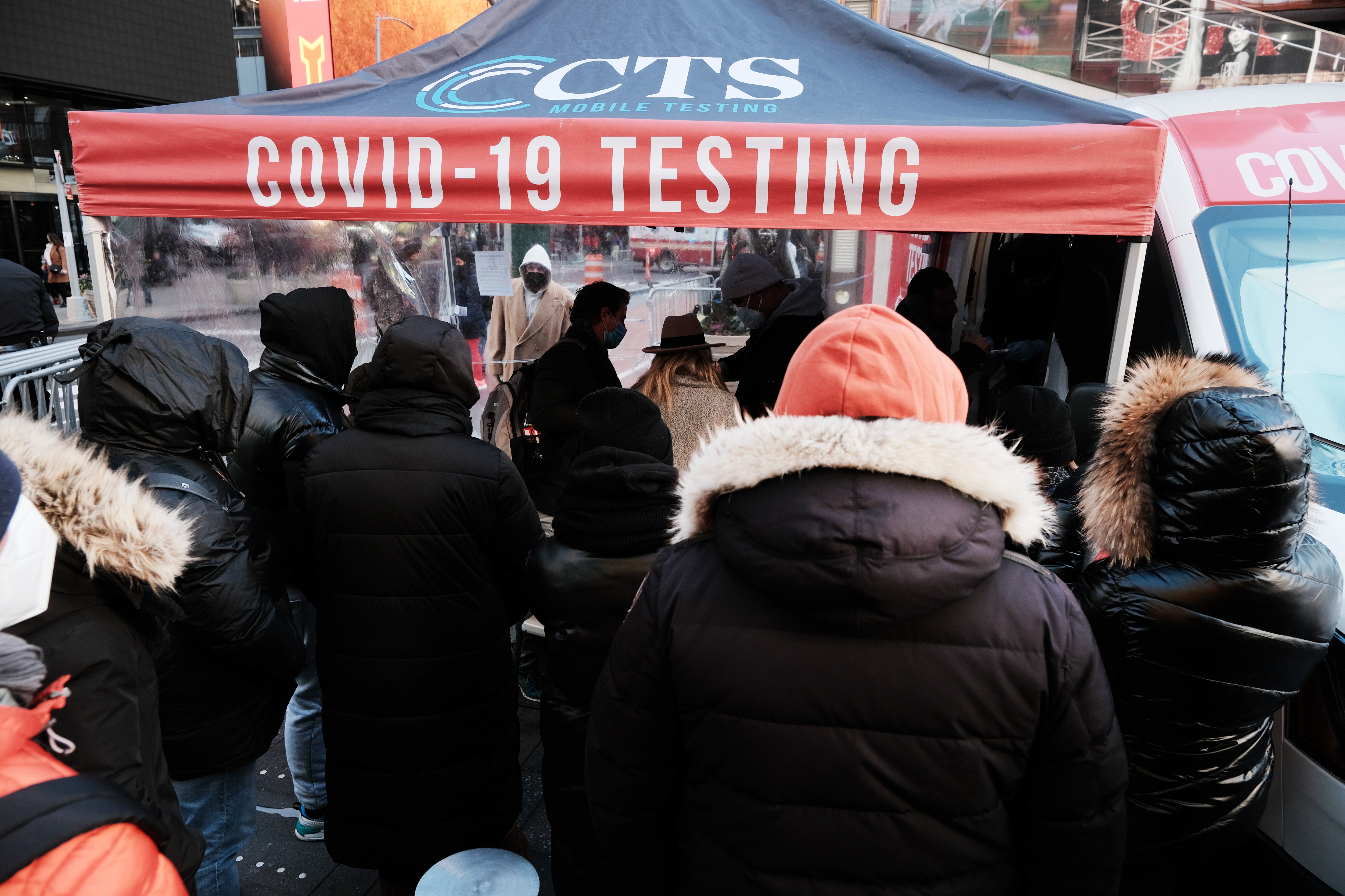 People wait in long lines in Times Square to get tested for Covid-19 on 20 December 2021 in New York City