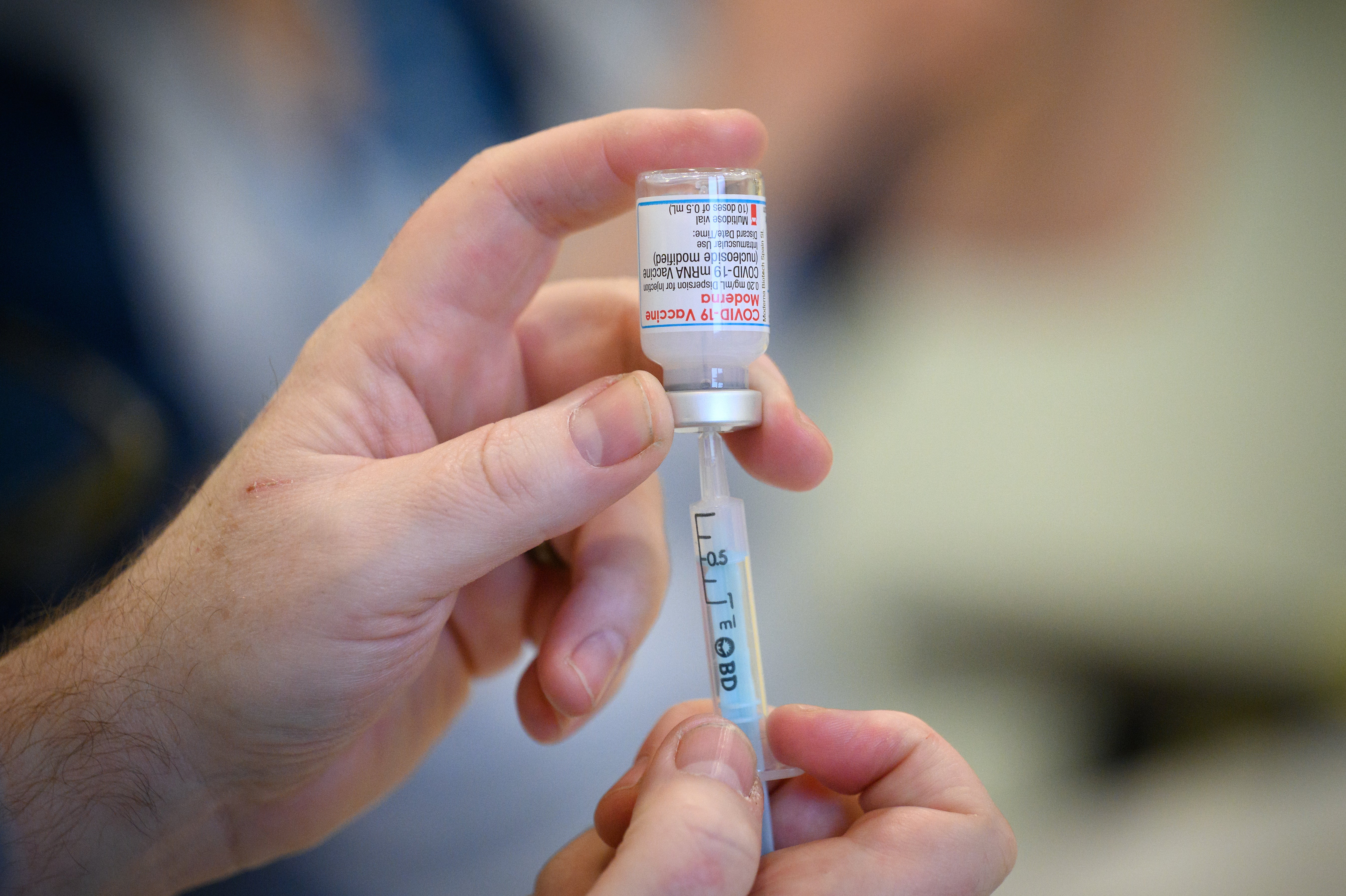 Medical staff and volunteers prepare shots of the Moderna vaccine at an NHS Covid-19 vaccination centre on 16 December 2021 near Ramsgate, United Kingdom