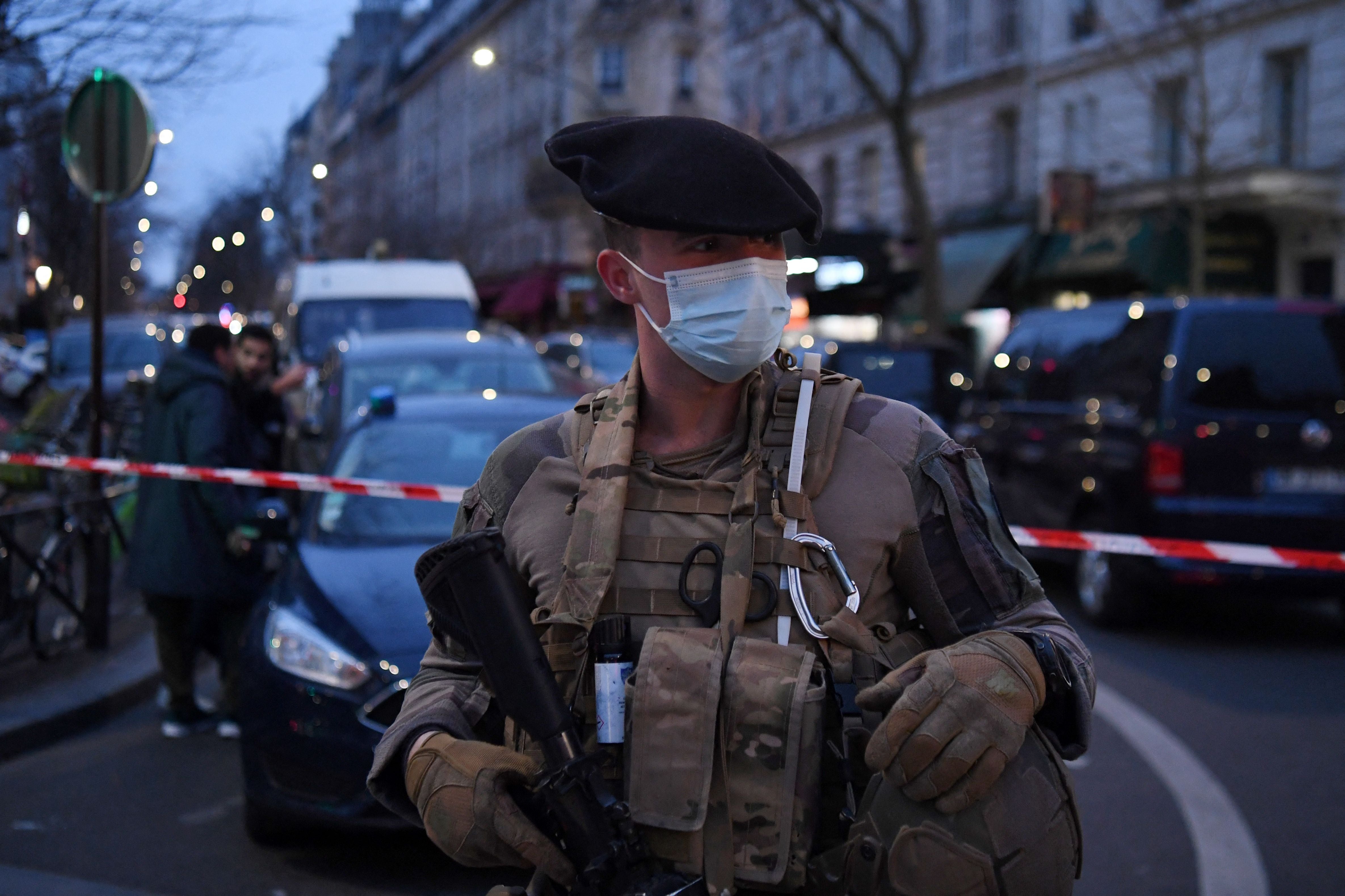 A French soldier stands guard at the scene of a hostage situation in Paris