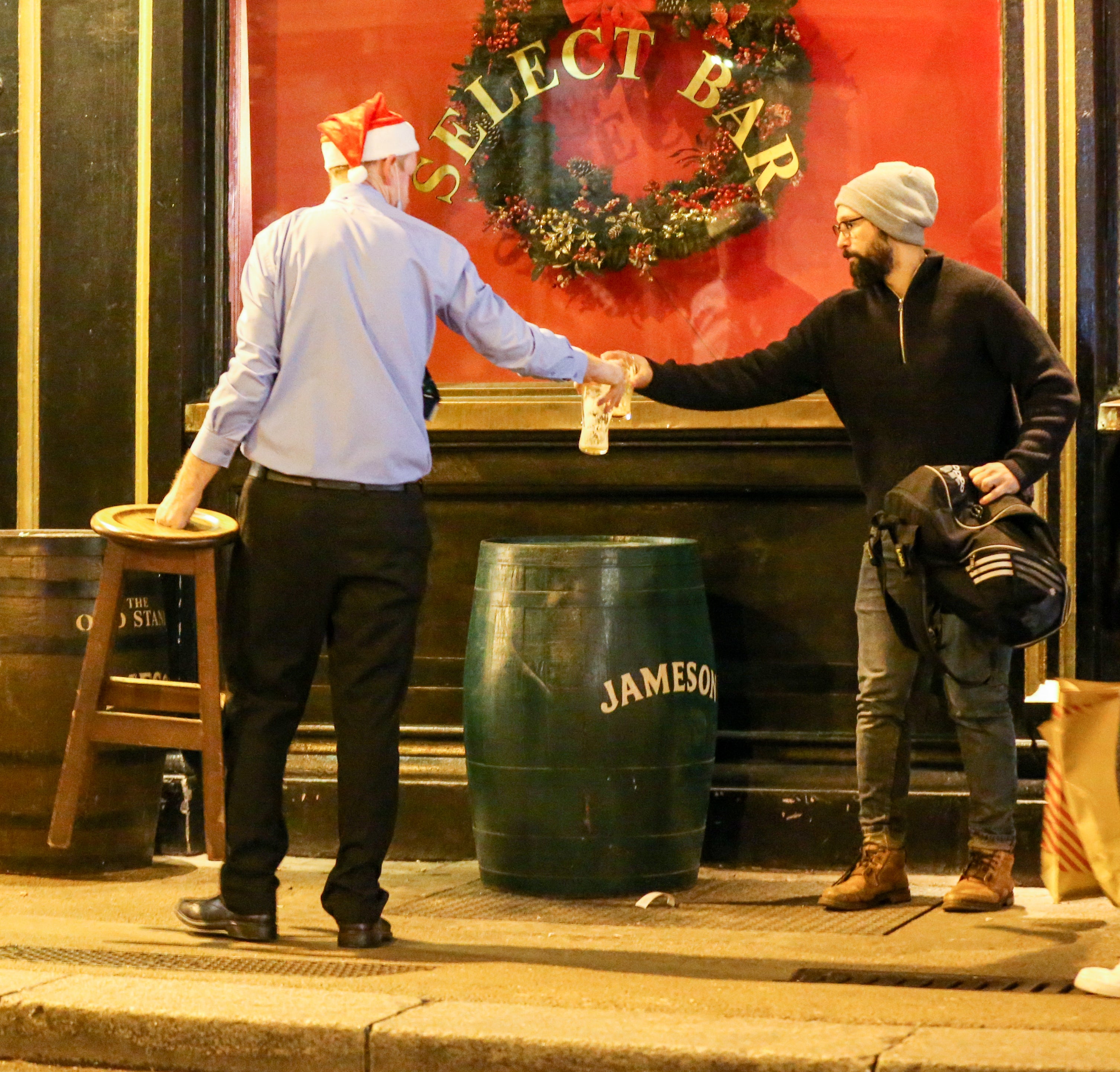 Bar workers clear tables and chairs (Damien Storan/PA)