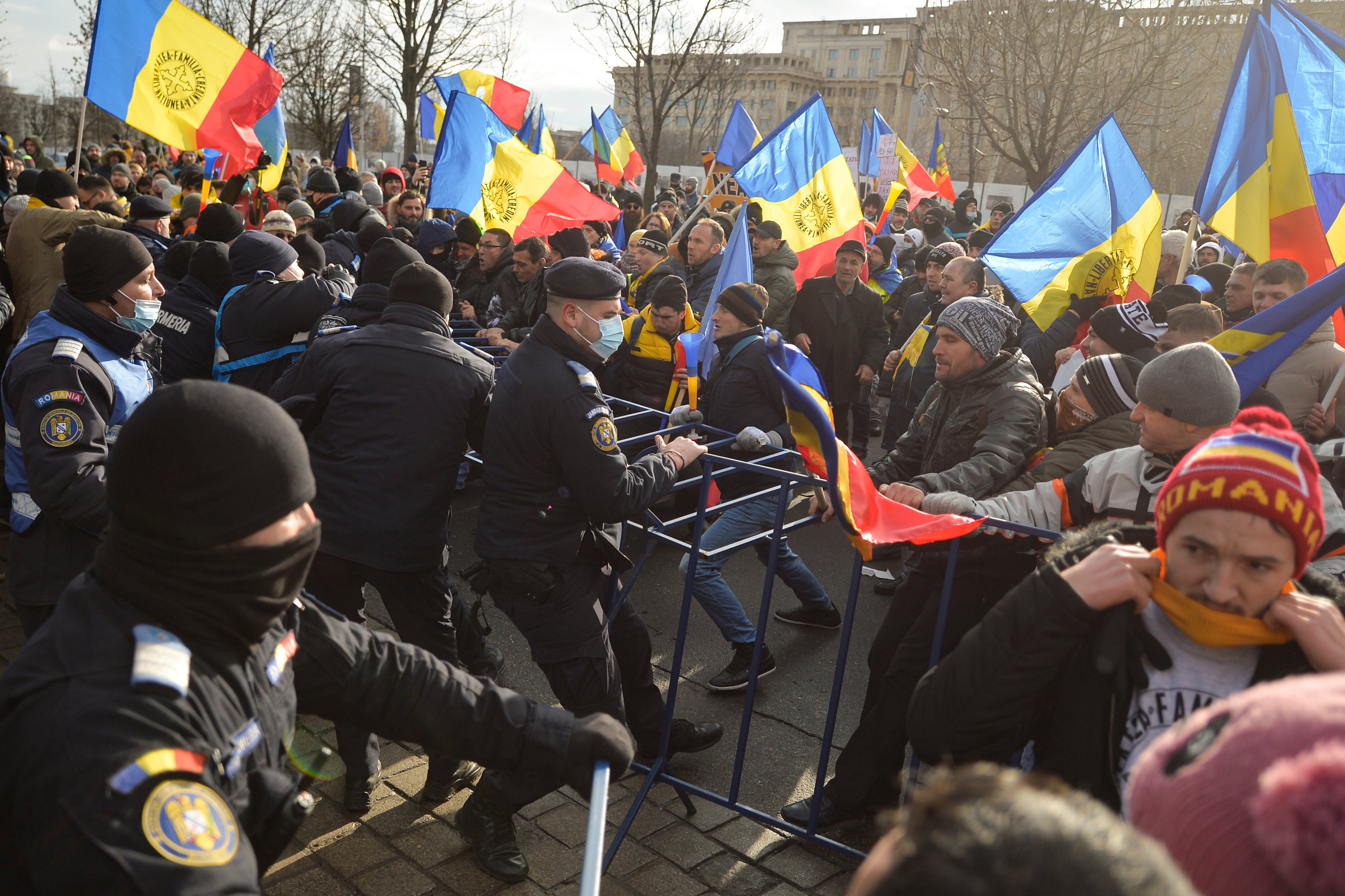 Riot police officers scuffle with protesters at the Palace of Parliament in Bucharest, Romania, on Tuesday