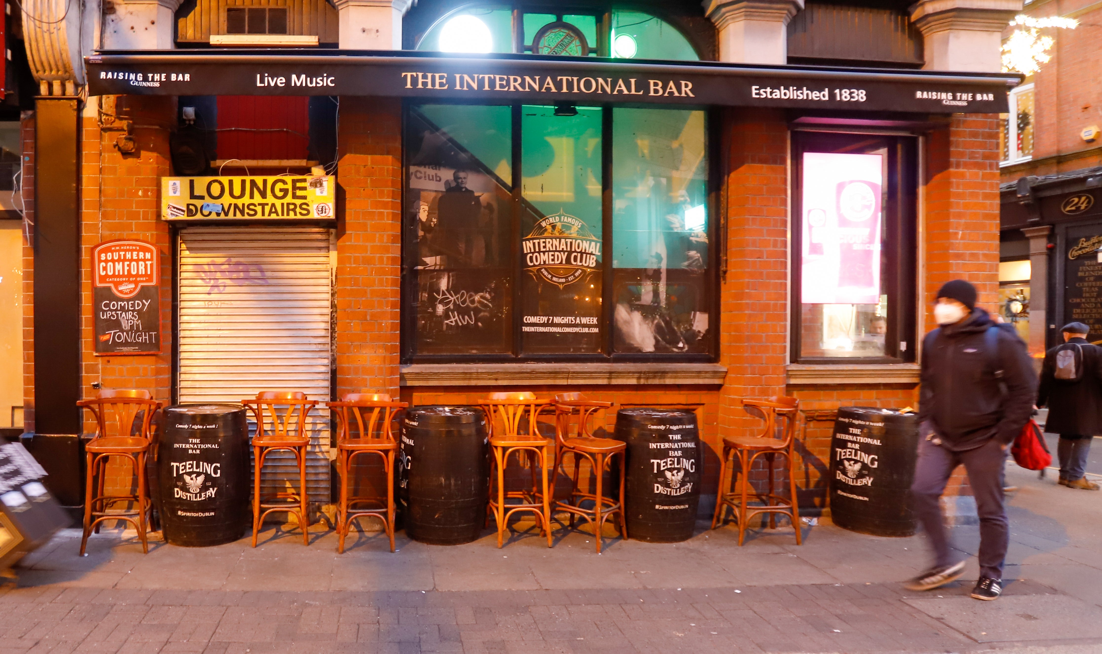 A man walks past empty seating outside a pub in Dublin (Damien Storan/PA)