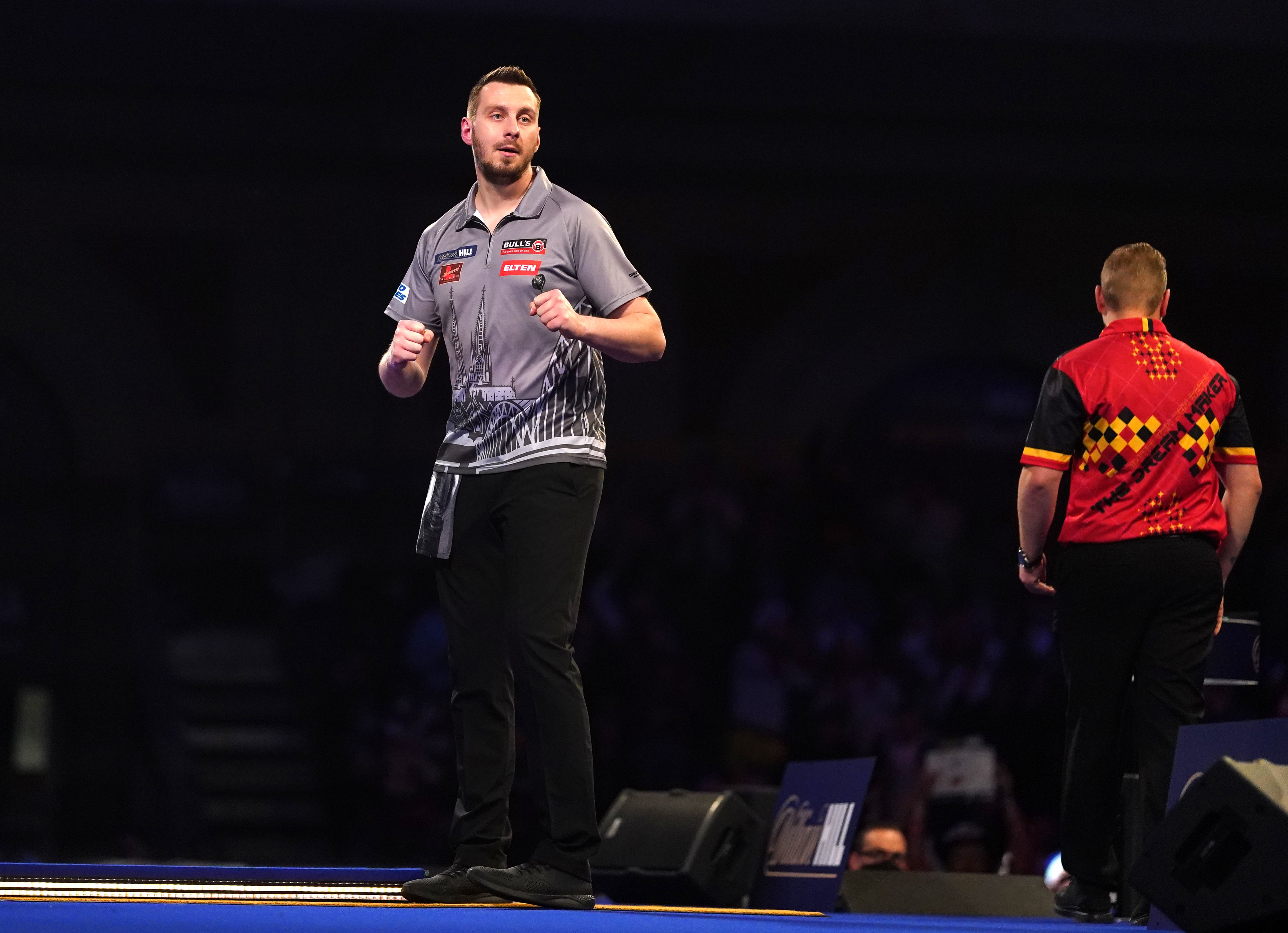 Florian Hempel (left) pulled off the shock of the tournament so far at Alexandra Palace (Adam Davy/PA)